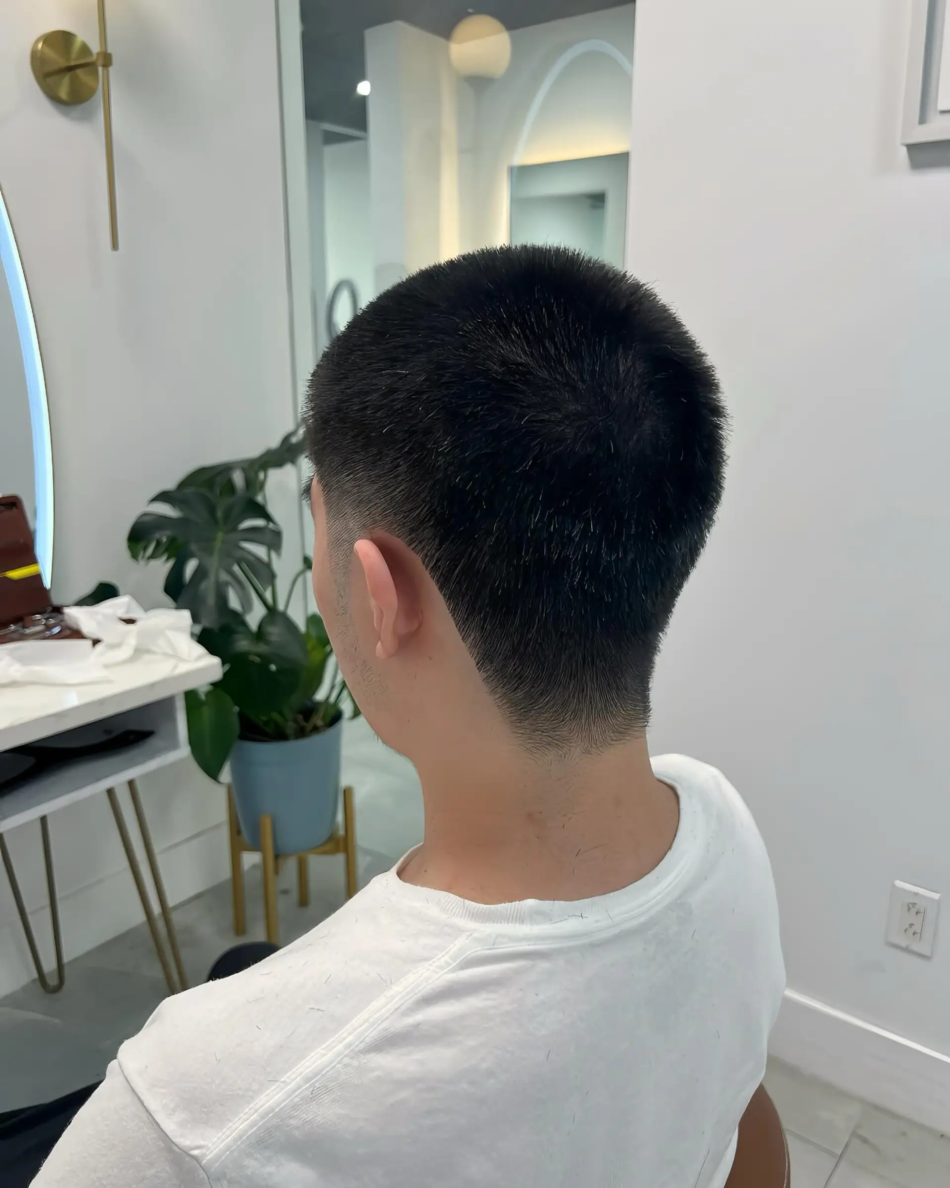 A classic buzz cut with a modern taper fade, offering a clean and low-maintenance style. 2