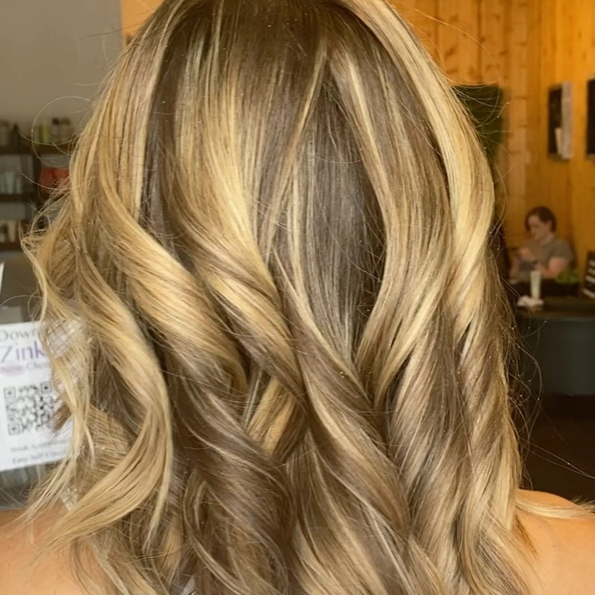 Medium-length dimensional golden blonde hair styled in loose, textured beach waves. 1