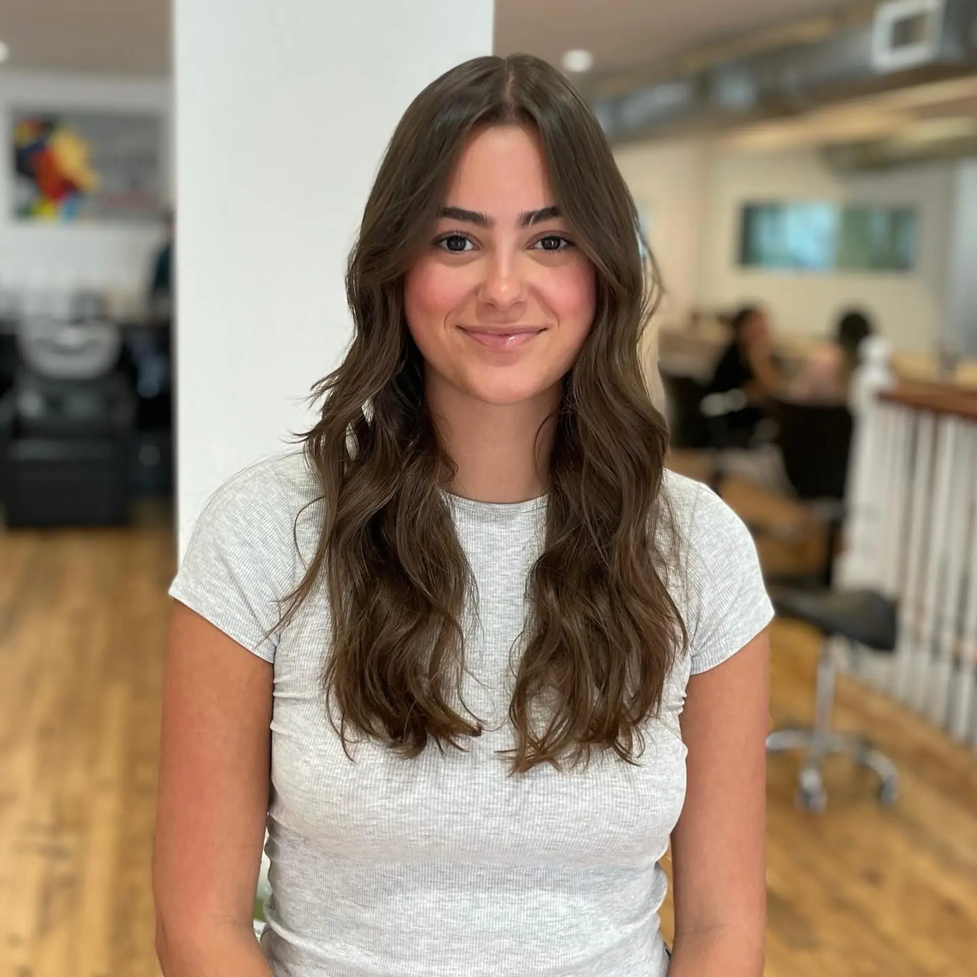 This hairstyle showcases long, flowing waves with subtle face-framing layers for an effortlessly chic look. 1