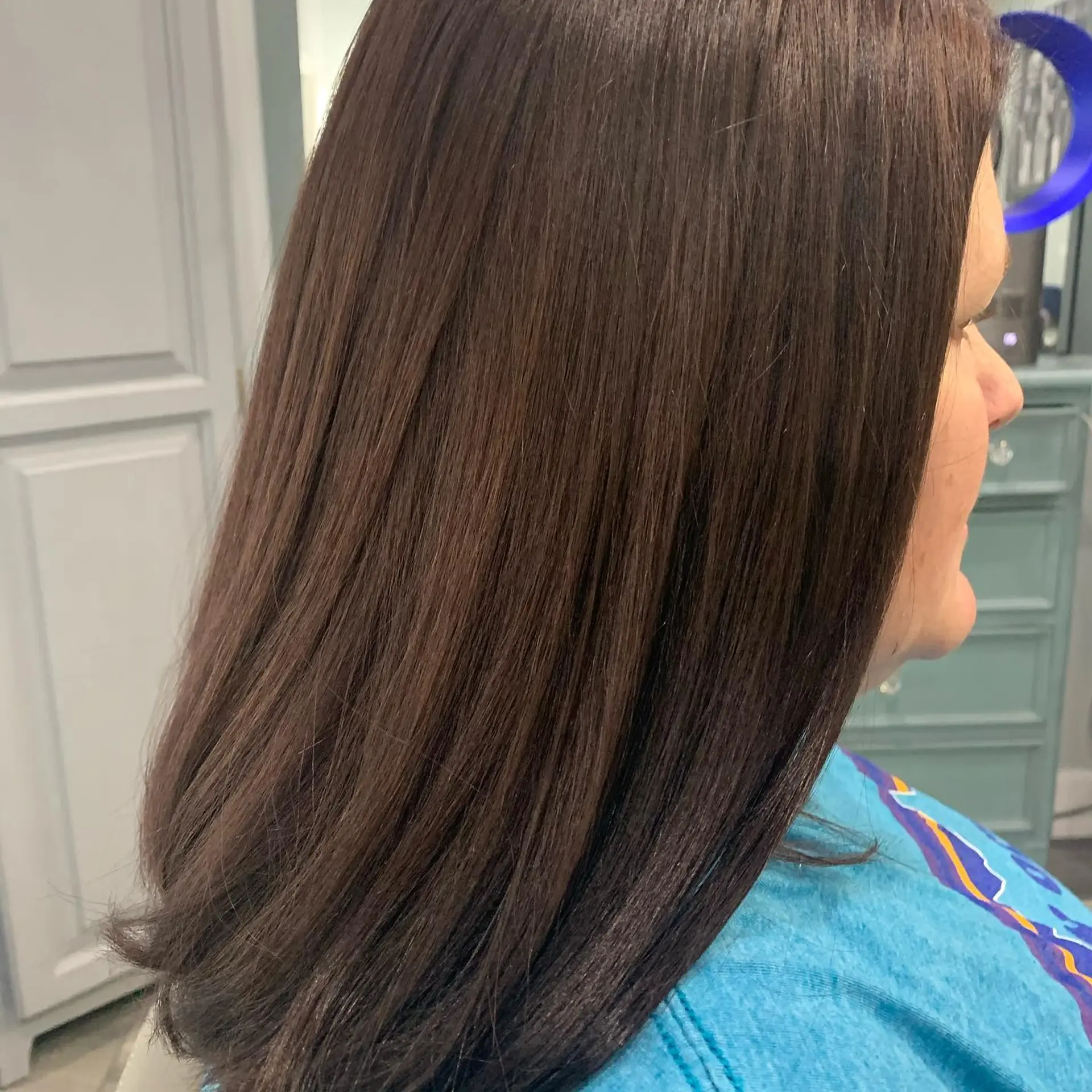 Medium-length straight dark chocolate brown hair styled smooth with a soft, rounded blowout finish. 1