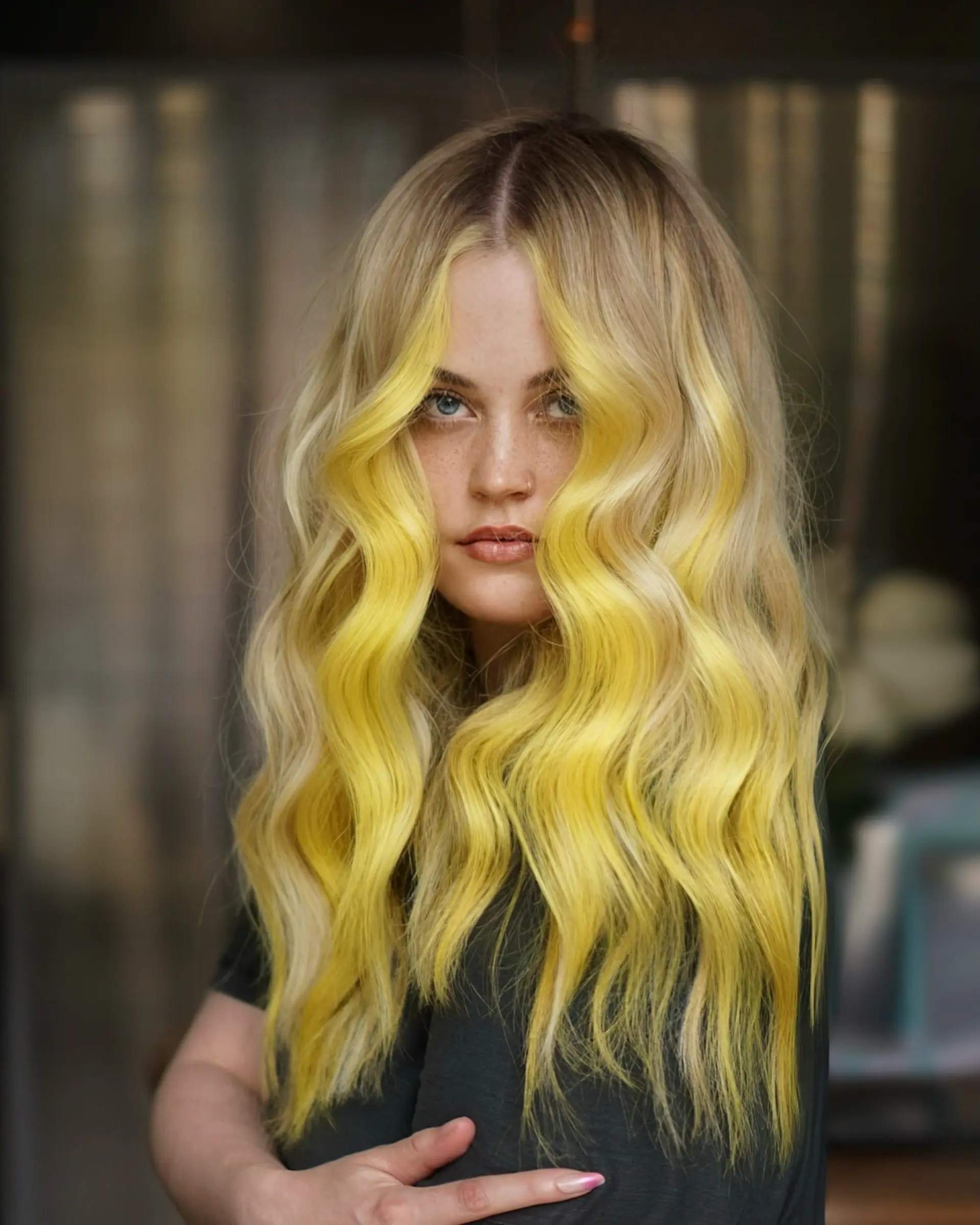 Long blonde hair styled into smooth, textured waves featuring a bold, vibrant neon lemon-yellow face frame. 1