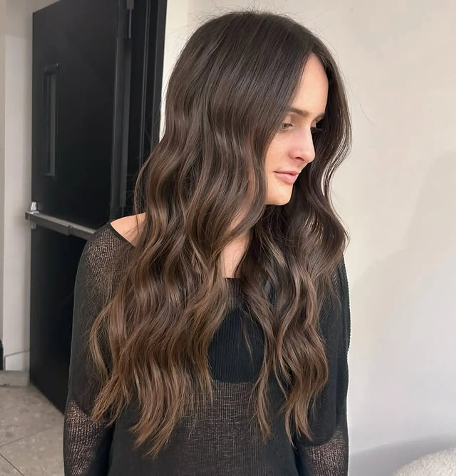 Long wavy hair with soft layers and face-framing pieces. 1