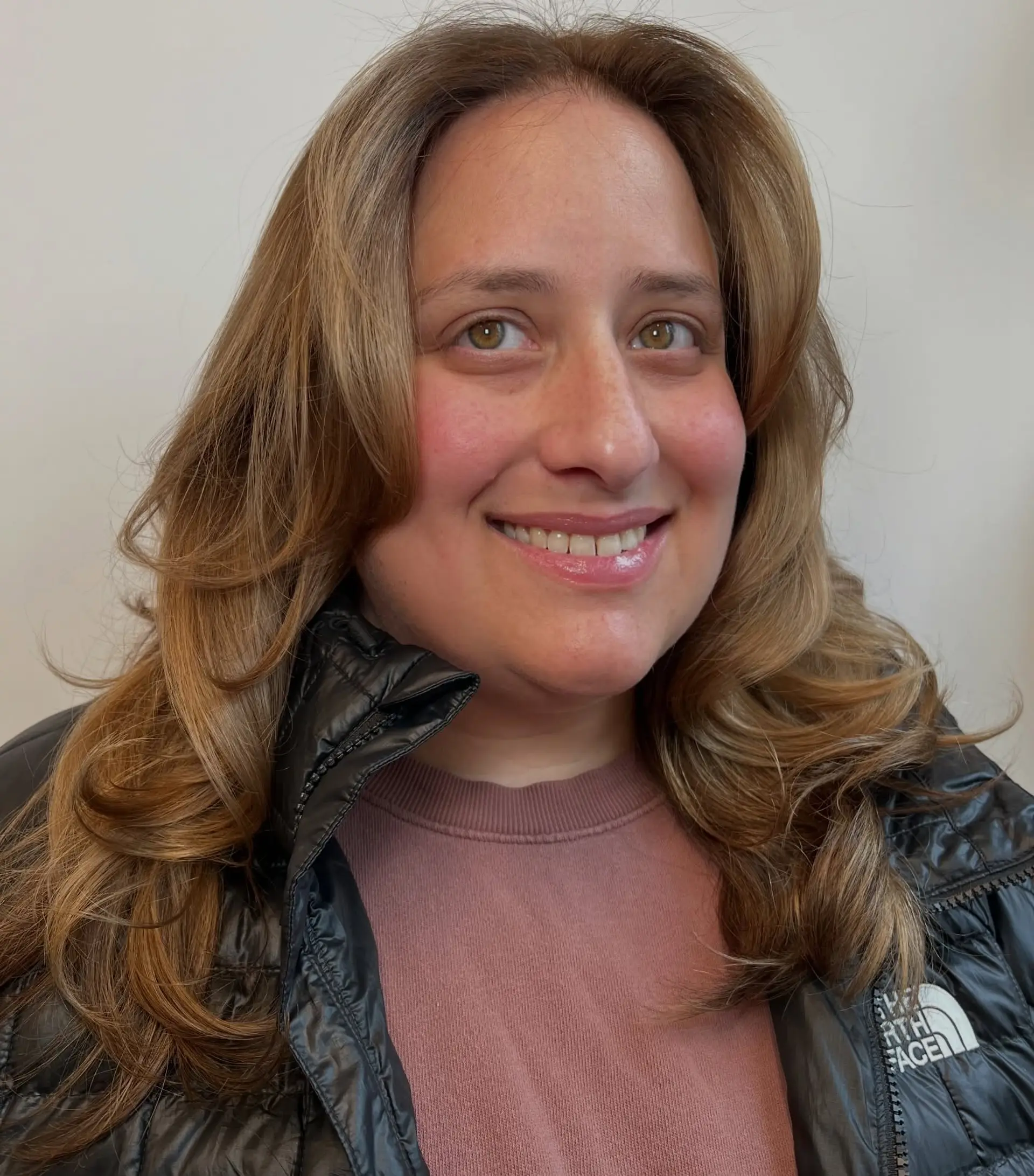 A voluminous butterfly haircut with feathered, face-framing layers and rounded, curled ends. 1