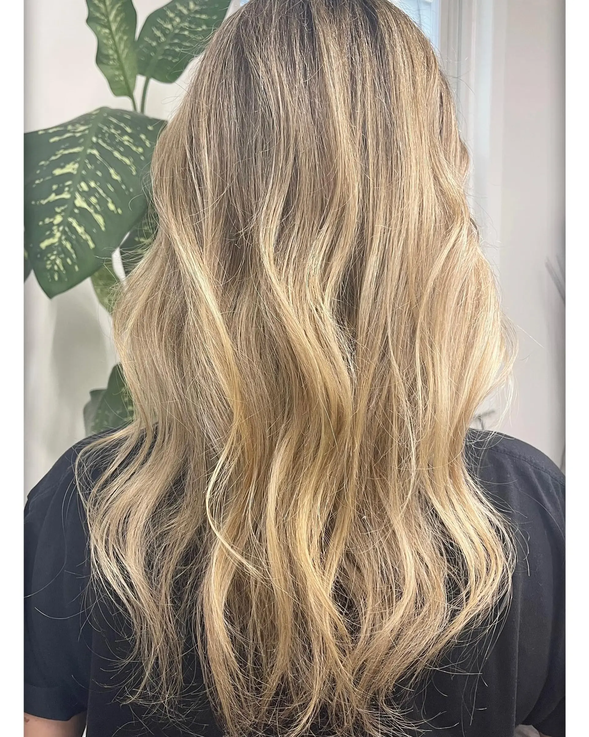 Long dimensional blonde hair styled in soft, loose waves with natural movement. 1