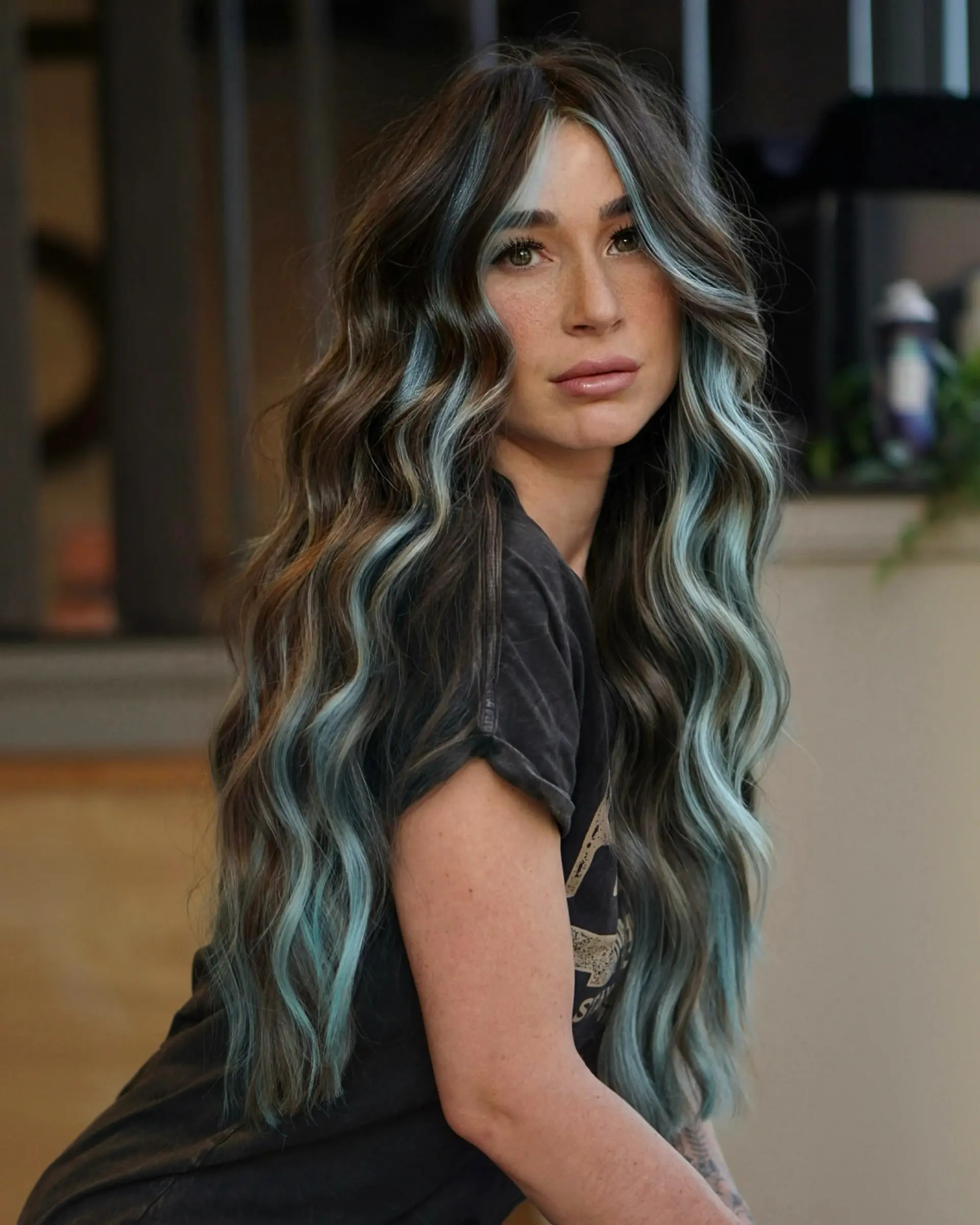 Long espresso brown waves featuring a bold, contrasting baby blue face-framing money piece. 1