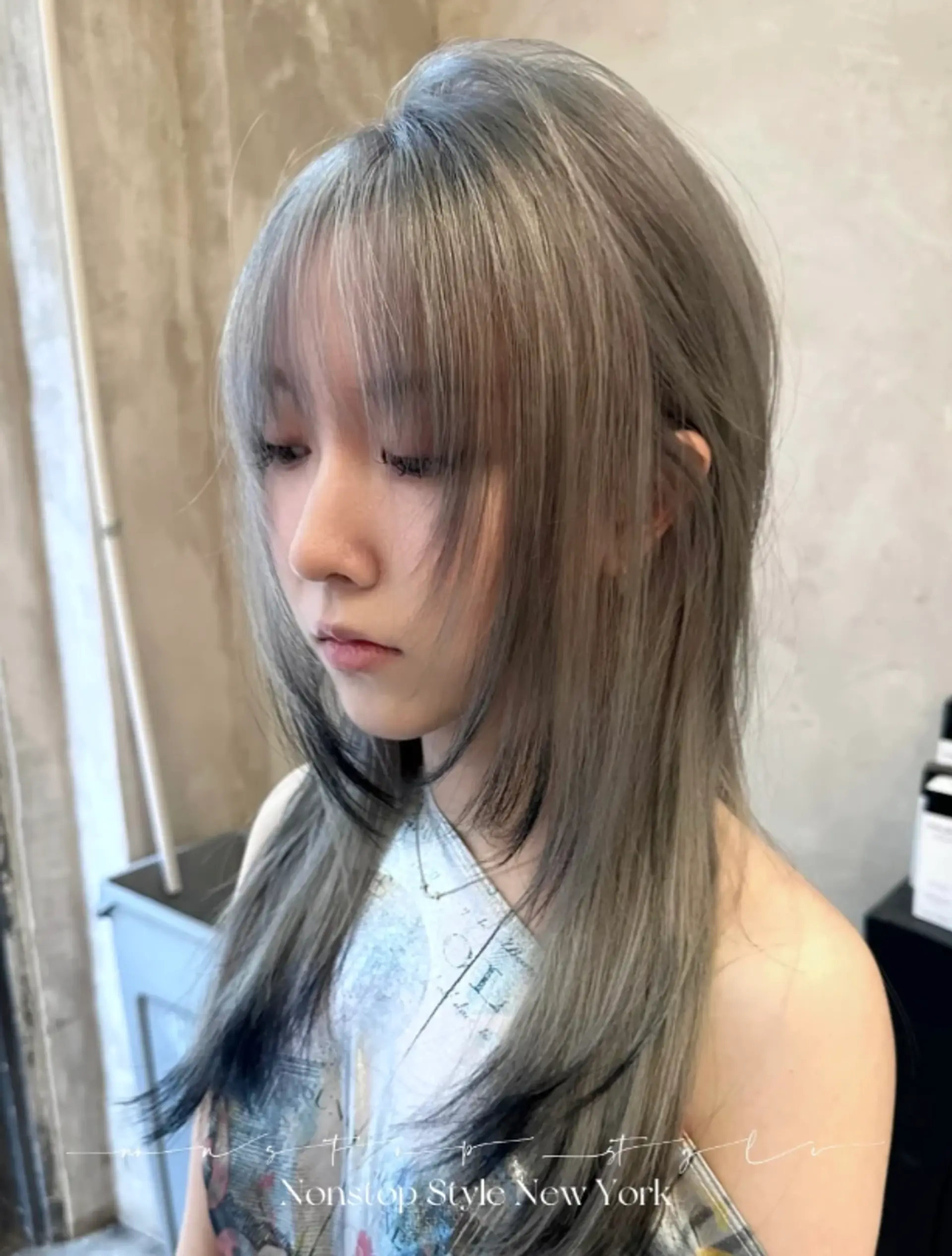 A long, straight hairstyle with a stunning ash gray and silver color palette, featuring intricate layers, a soft fringe, and delicate, face-framing layers.
(NonstopStyle: by Hiro) 1