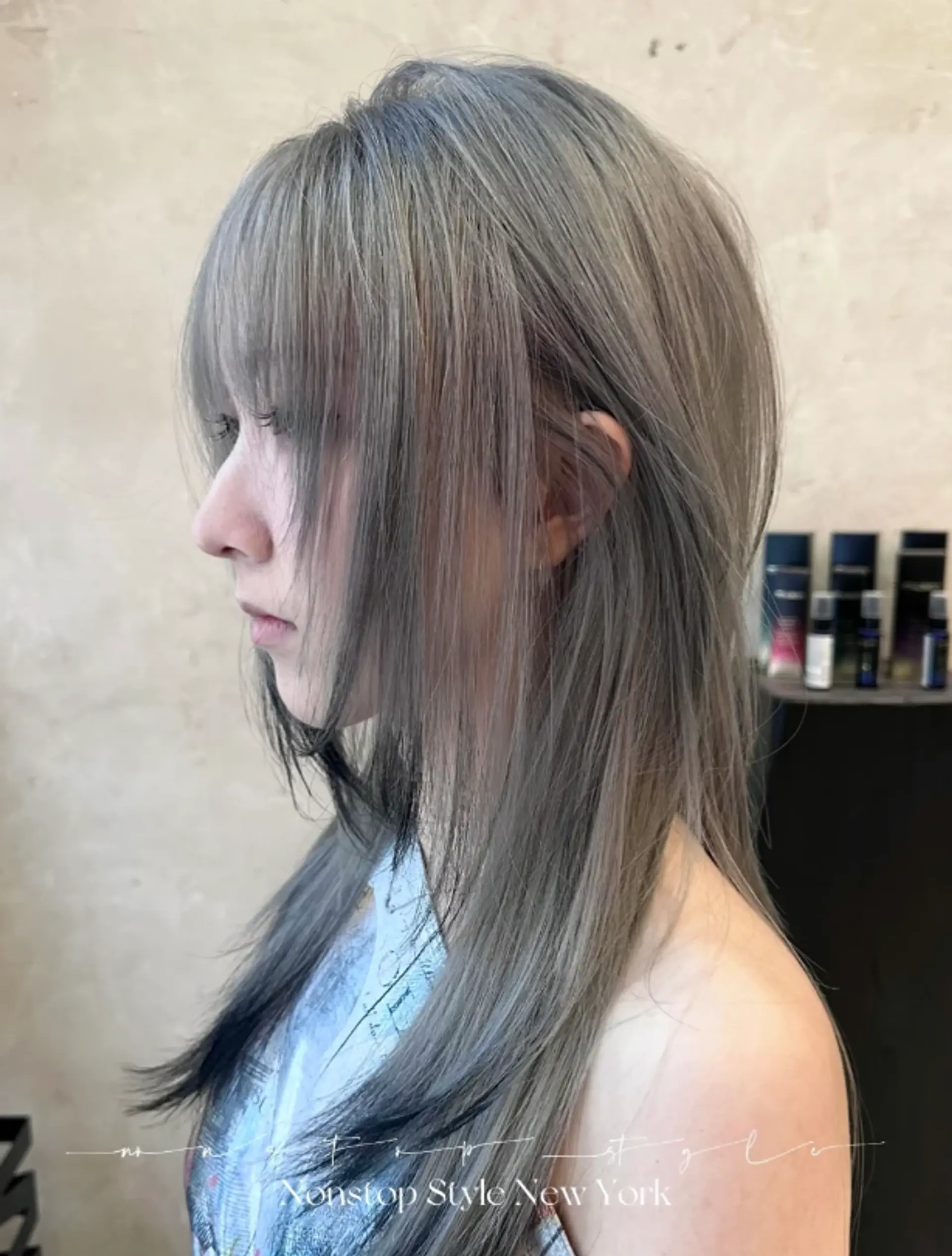A long, straight hairstyle with a stunning ash gray and silver color palette, featuring intricate layers, a soft fringe, and delicate, face-framing layers.
(NonstopStyle: by Hiro) 3