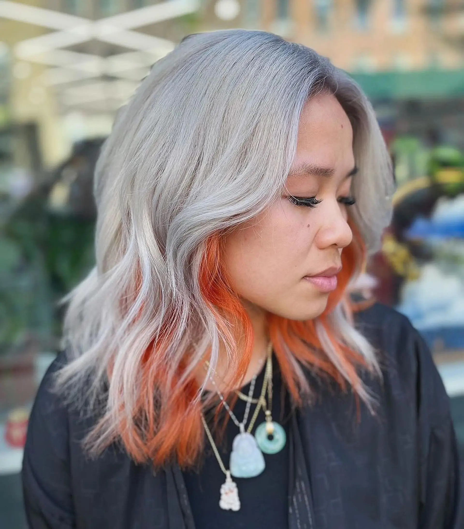 Medium-length, wavy hair with a gradient color transition from silver at the roots to orange at the ends, styled in loose waves.
Stylist - @xcellent_jason 1