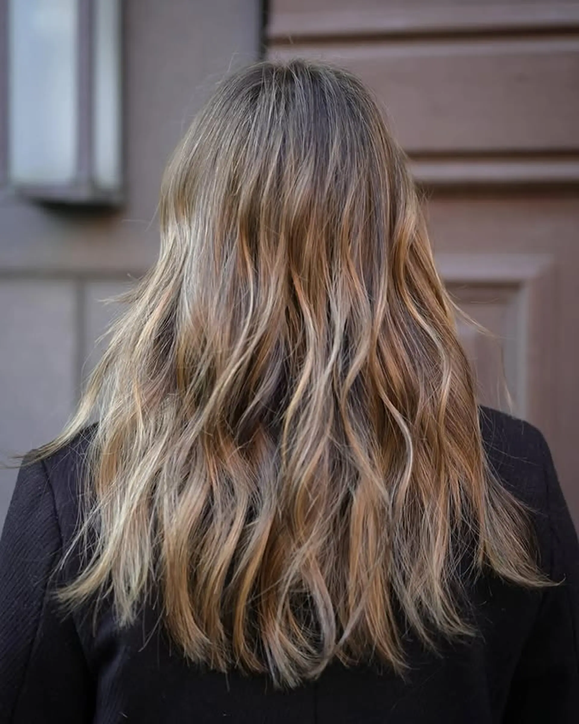 Long, layered hair with a bronde balayage. 1