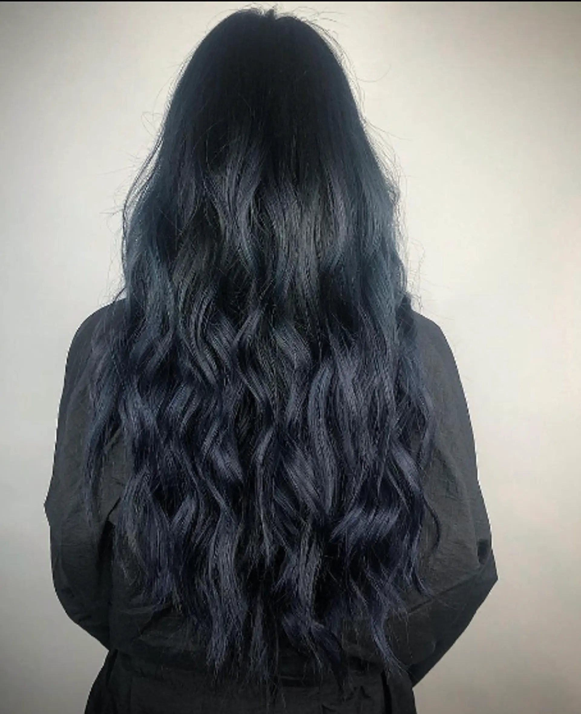 Very long, wavy hair with a deep black base color and subtle blue undertones, loose waves, and a smooth, shiny texture. 1