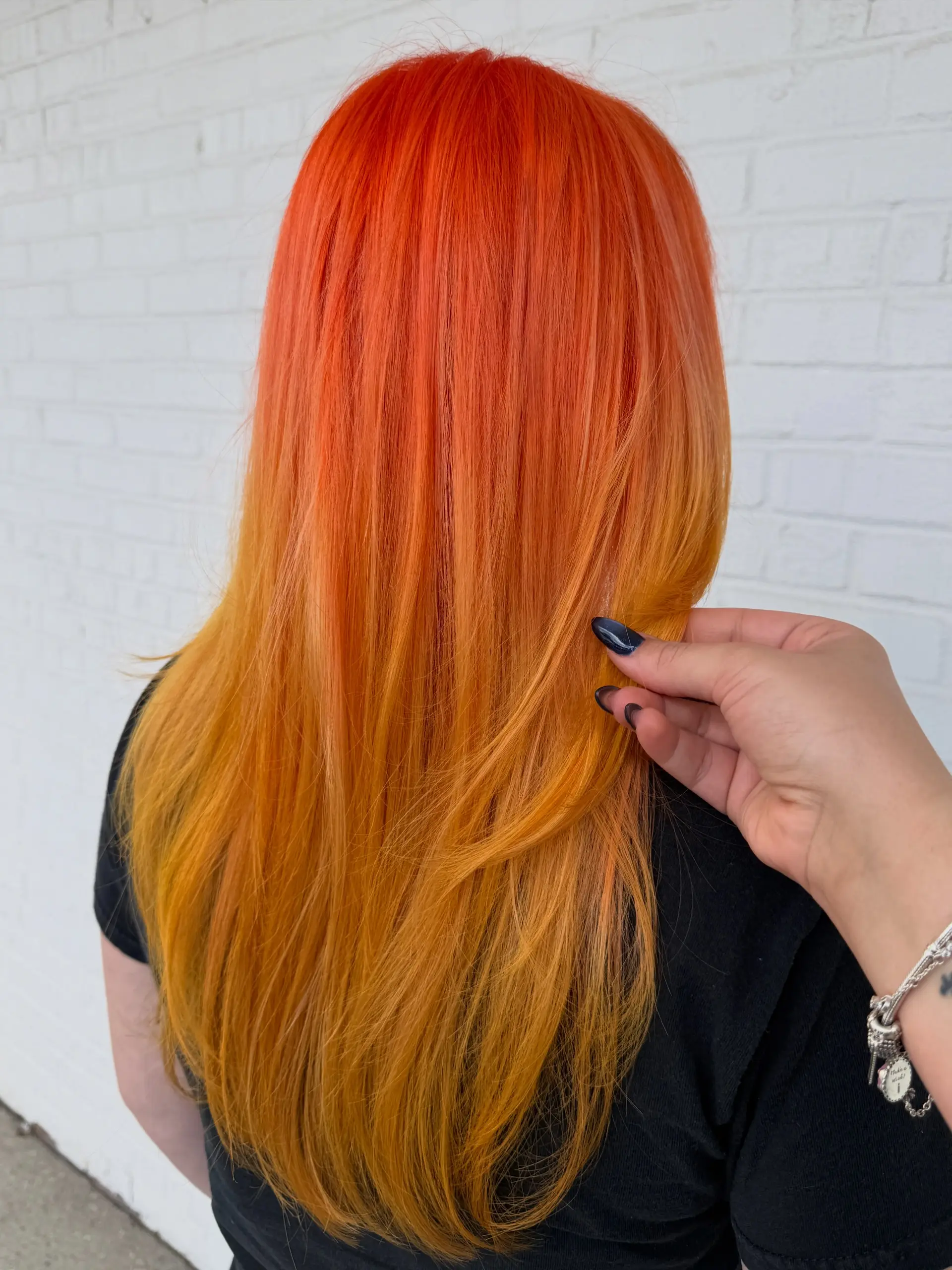 Vibrant, neon orange hair with subtle warm yellow undertones, styled straight and smooth down the back. 1