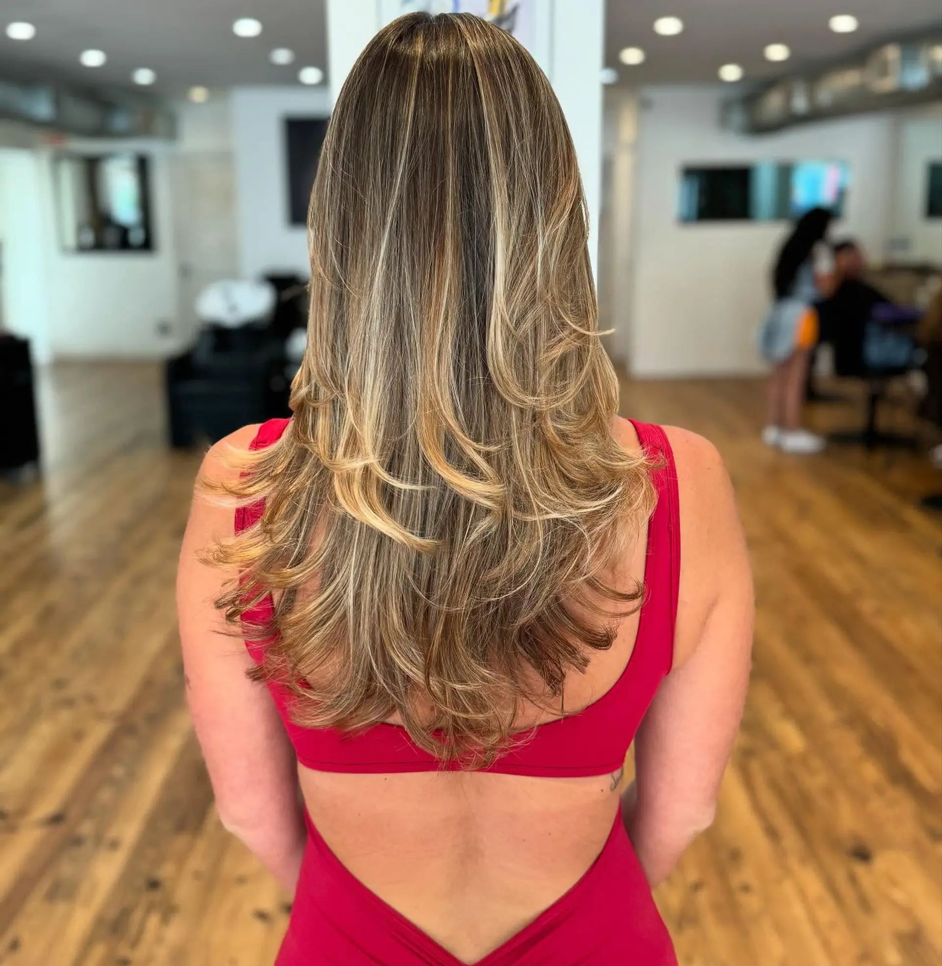 Long layered haircut with a bronde balayage. 1