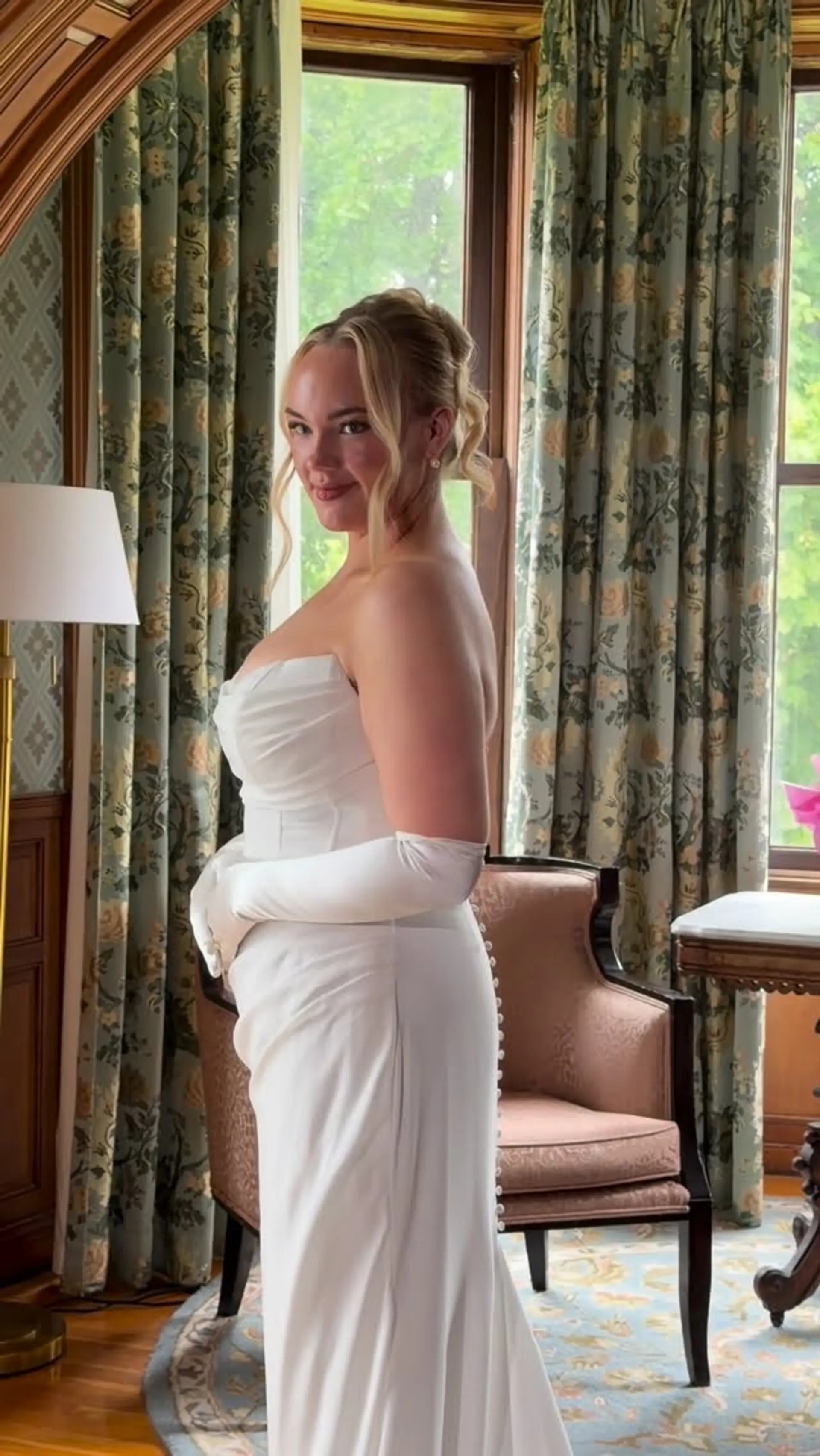 A romantic bridal updo with soft curls pinned up and gentle face-framing tendrils left loose. 1