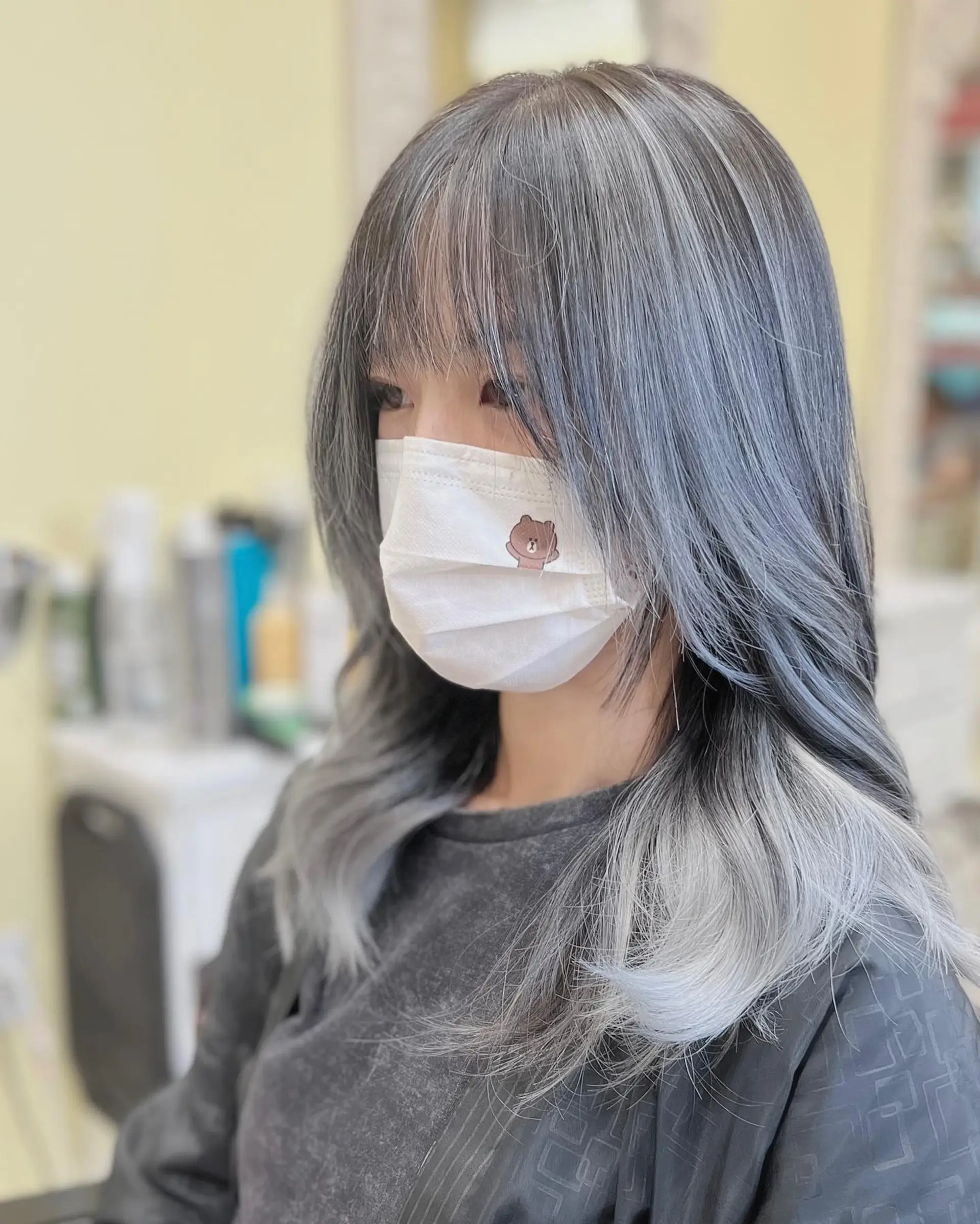 Medium-length straight hair with soft waves, face-framing layers, and a silver-blue ombre color. 1