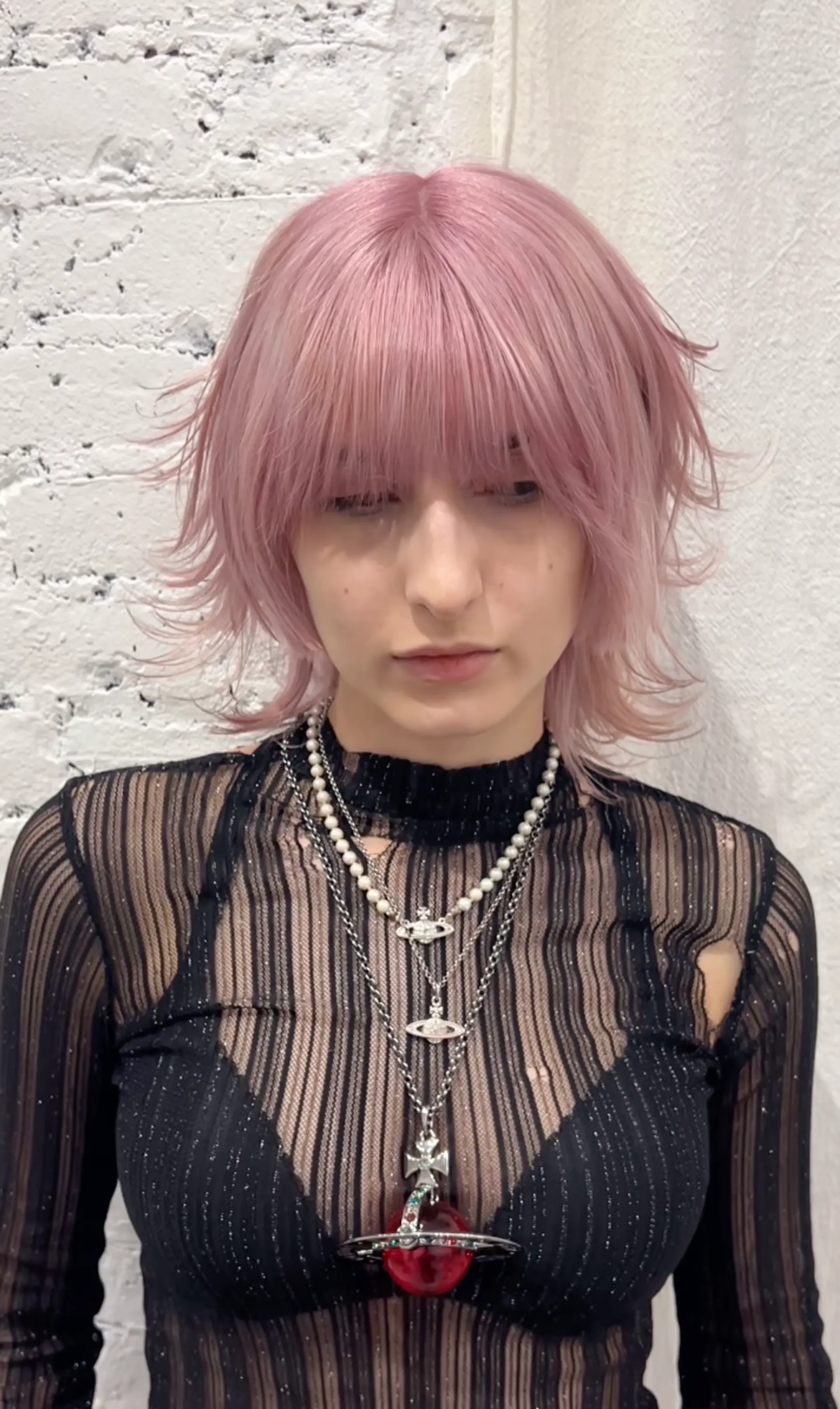 Straight, medium-length hair colored in pastel lavender-pink, with feathered layers, fringed bangs, and choppy ends, creating an edgy and voluminous look. 1