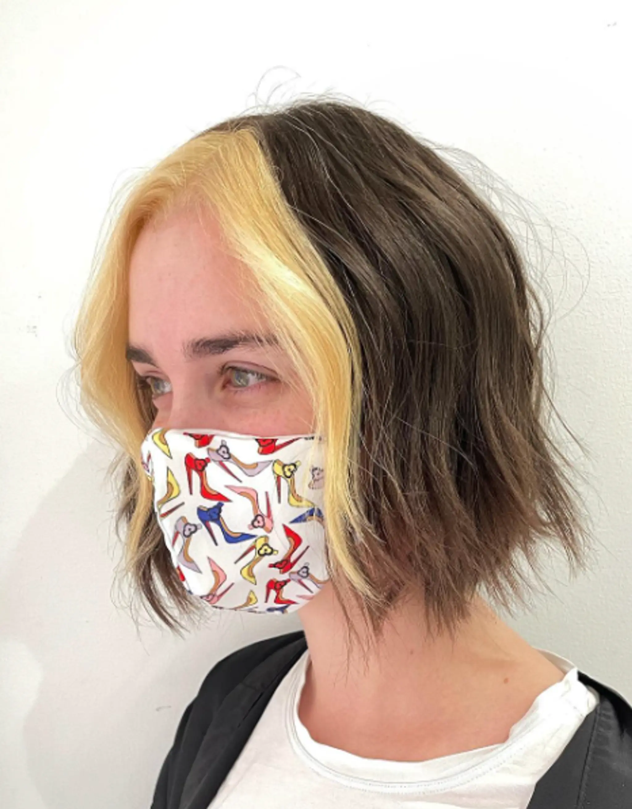 A short, wavy bob cut with a rich brown base and vibrant blonde front sections, featuring textured ends and face-framing highlights.