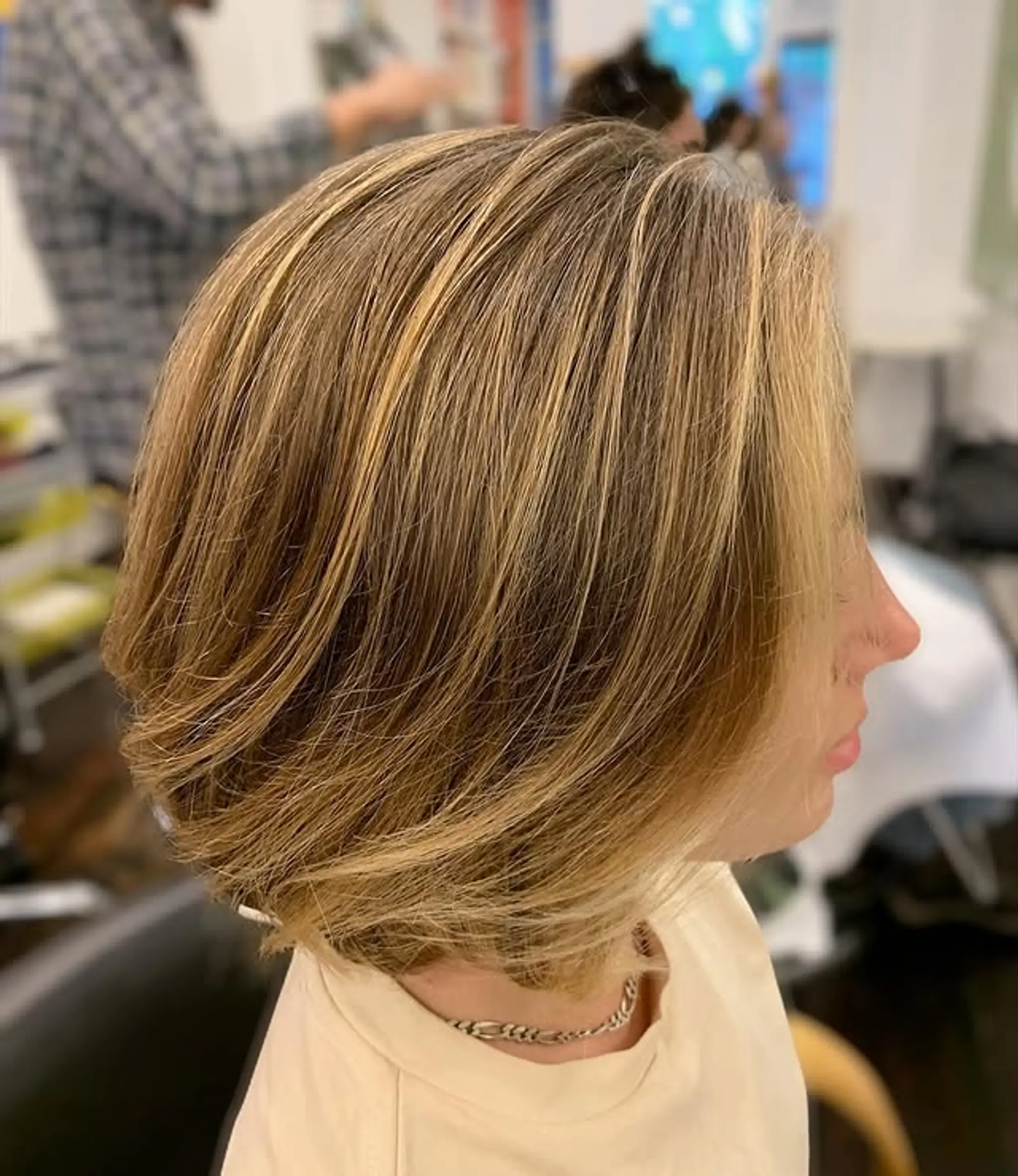 A classic layered bob with subtle highlights, adding movement and dimension to straight hair.