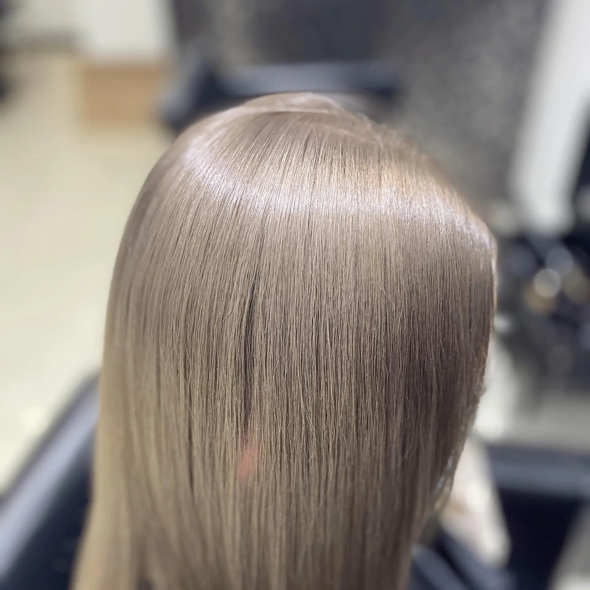 Long, sleek, and silky straight hair in a trendy ash blonde color. 1