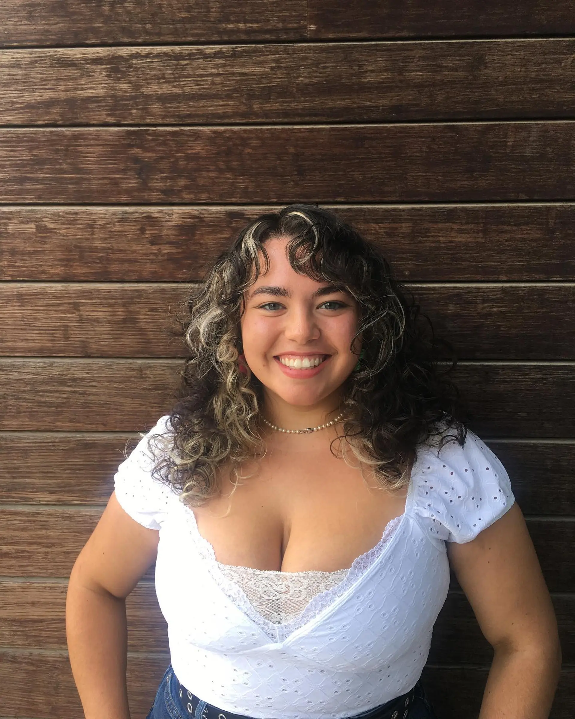 Shoulder-length natural curls with curly bangs, featuring bold blonde color-blocked highlights against a dark brown base. 1