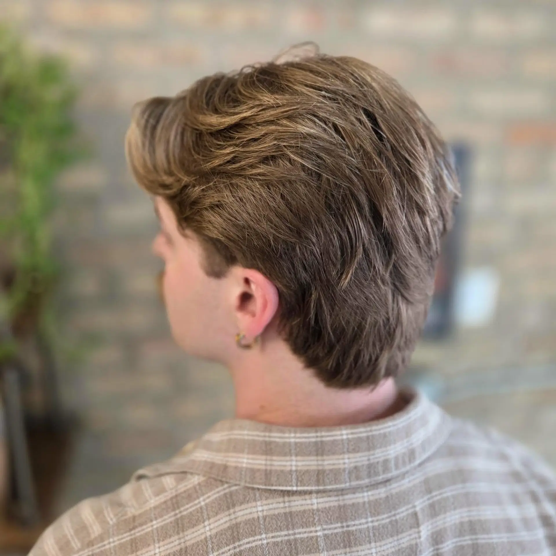 A soft, textured flow haircut with natural movement, layered volume through the crown, and tapered length at the nape. 1
