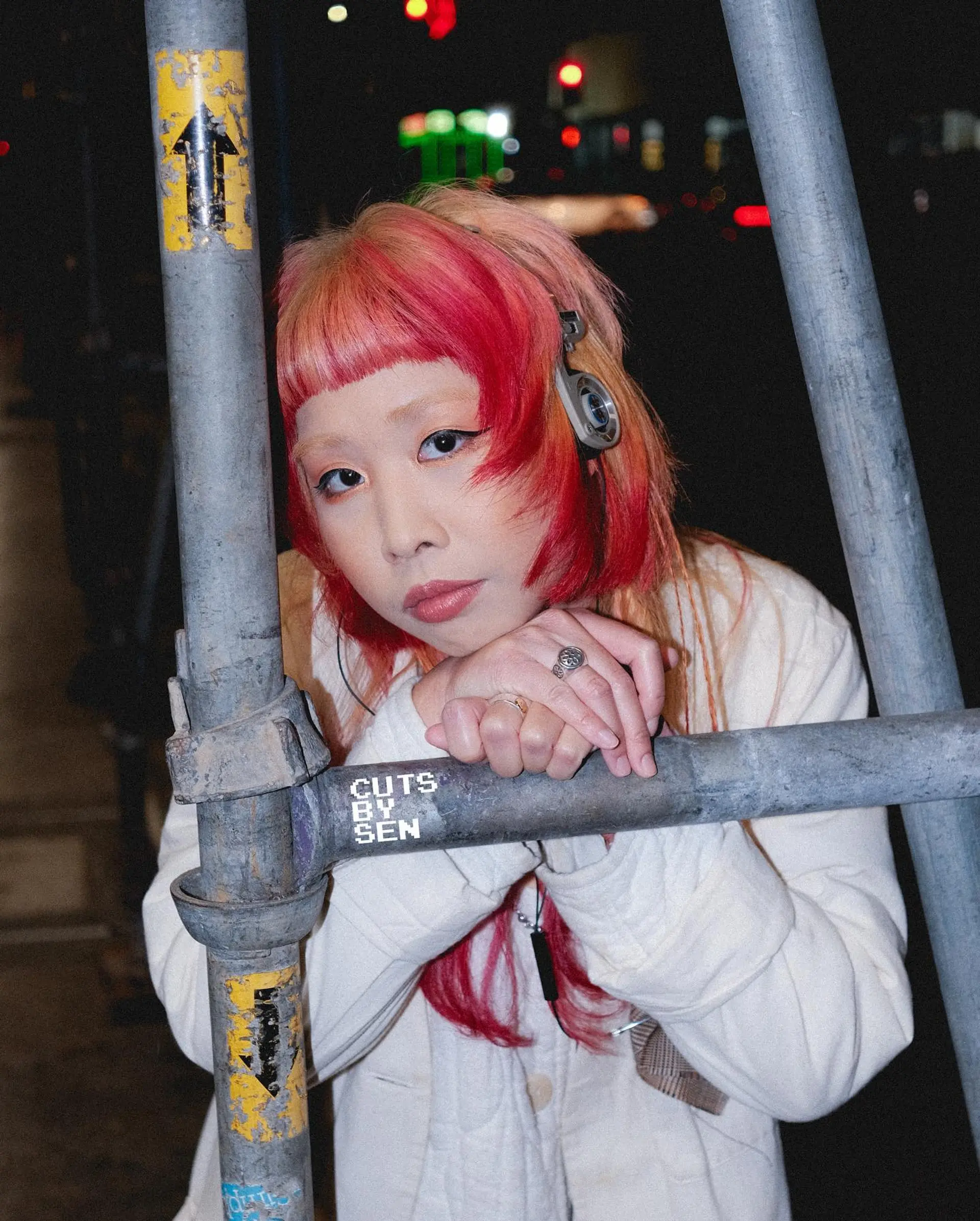 A modern, textured take on the Japanese hime cut featuring blunt micro bangs, choppy face-framing side steps, and vibrant hot pink and peachy-blonde color blocking. 1
