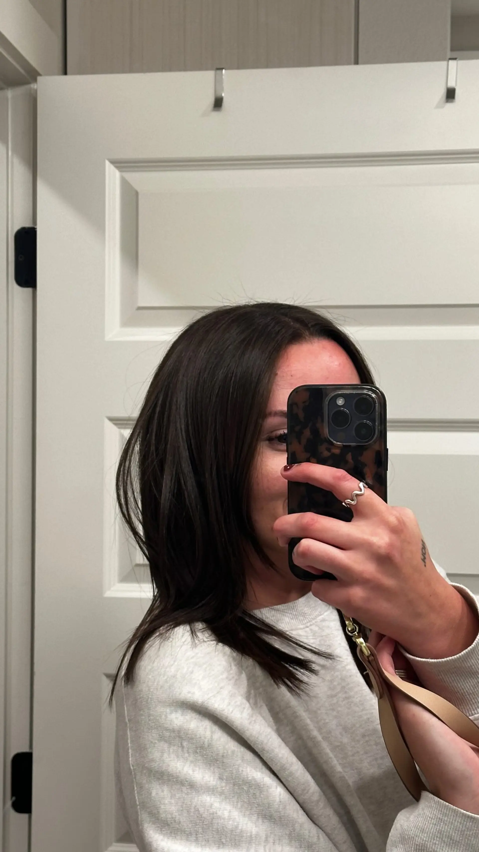 A textured shoulder-length dark brown lob featuring soft layers and piecey ends. 1