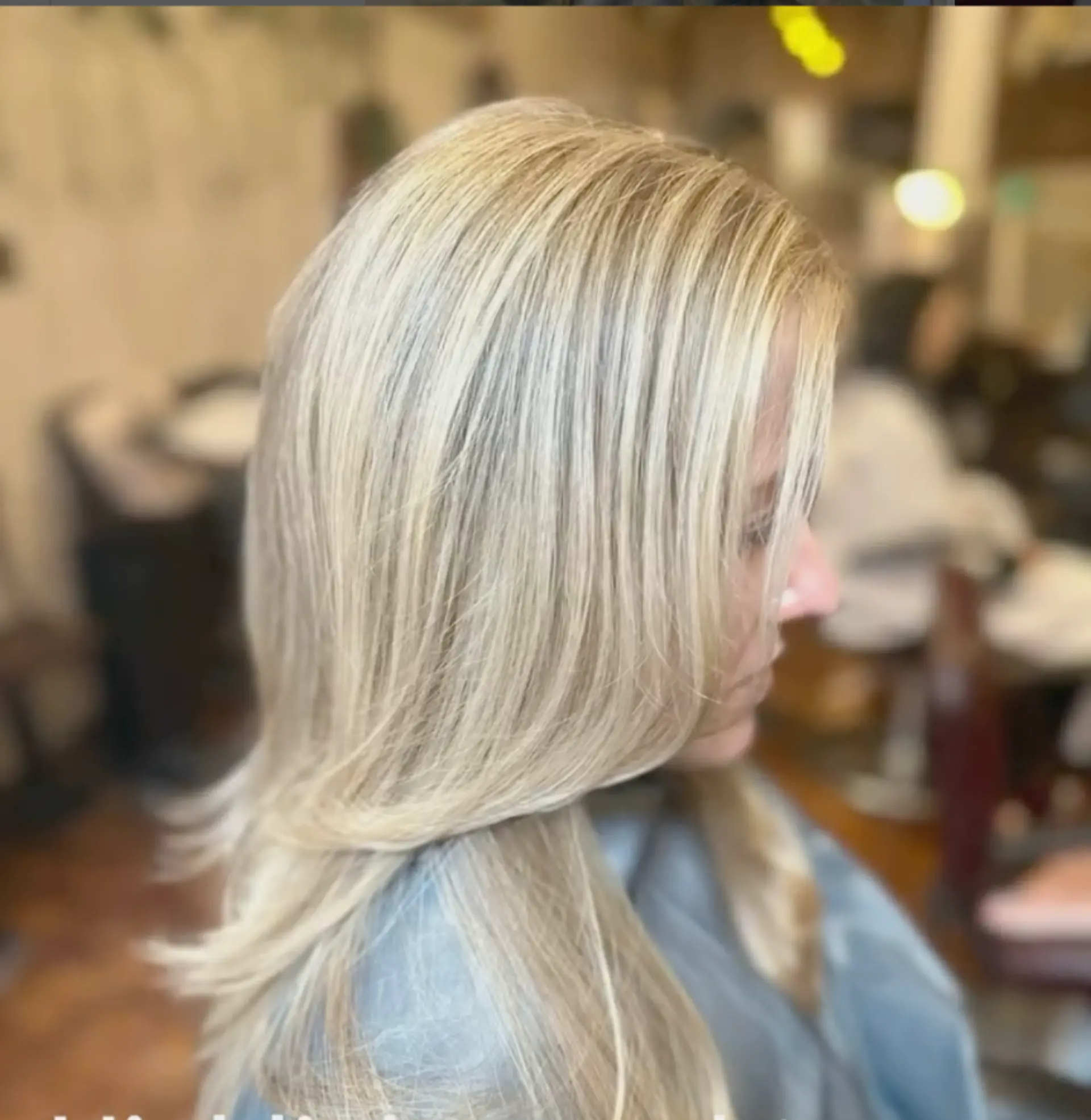 A medium-length straight hairstyle with blonde highlights and layered cut. 1