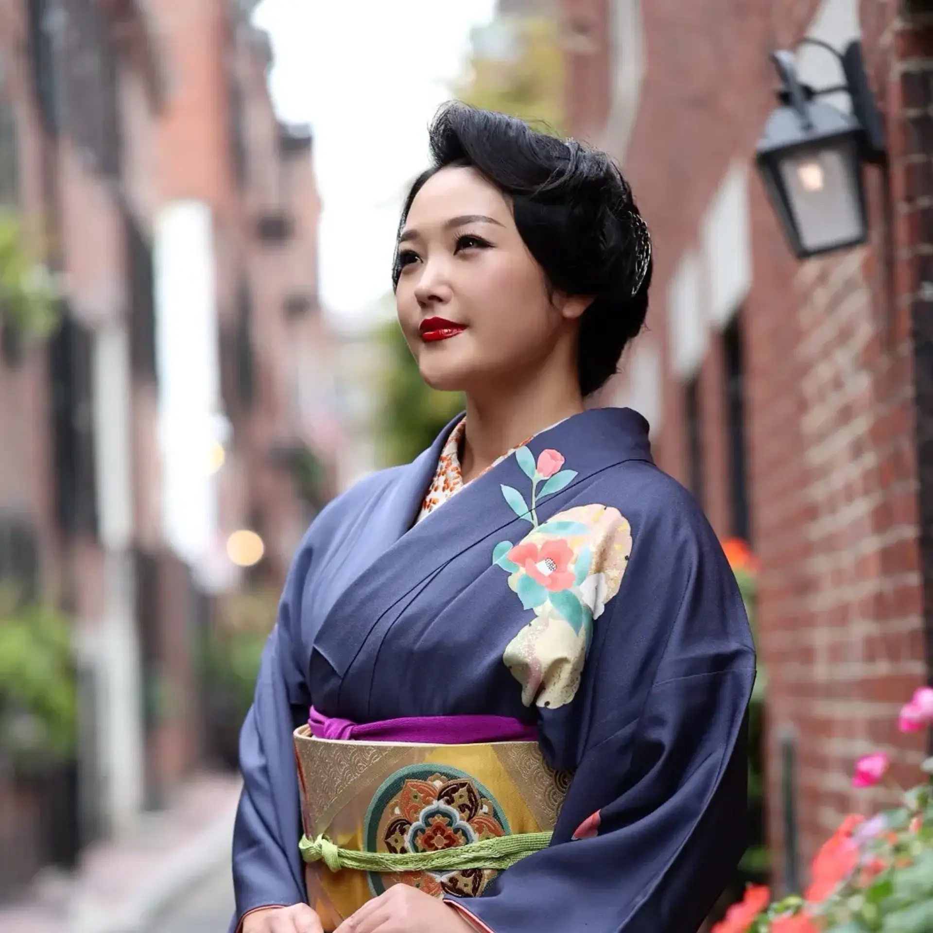 An elegant, sculpted formal updo with sleek roll waves at the front, paired with traditional Japanese attire. 1