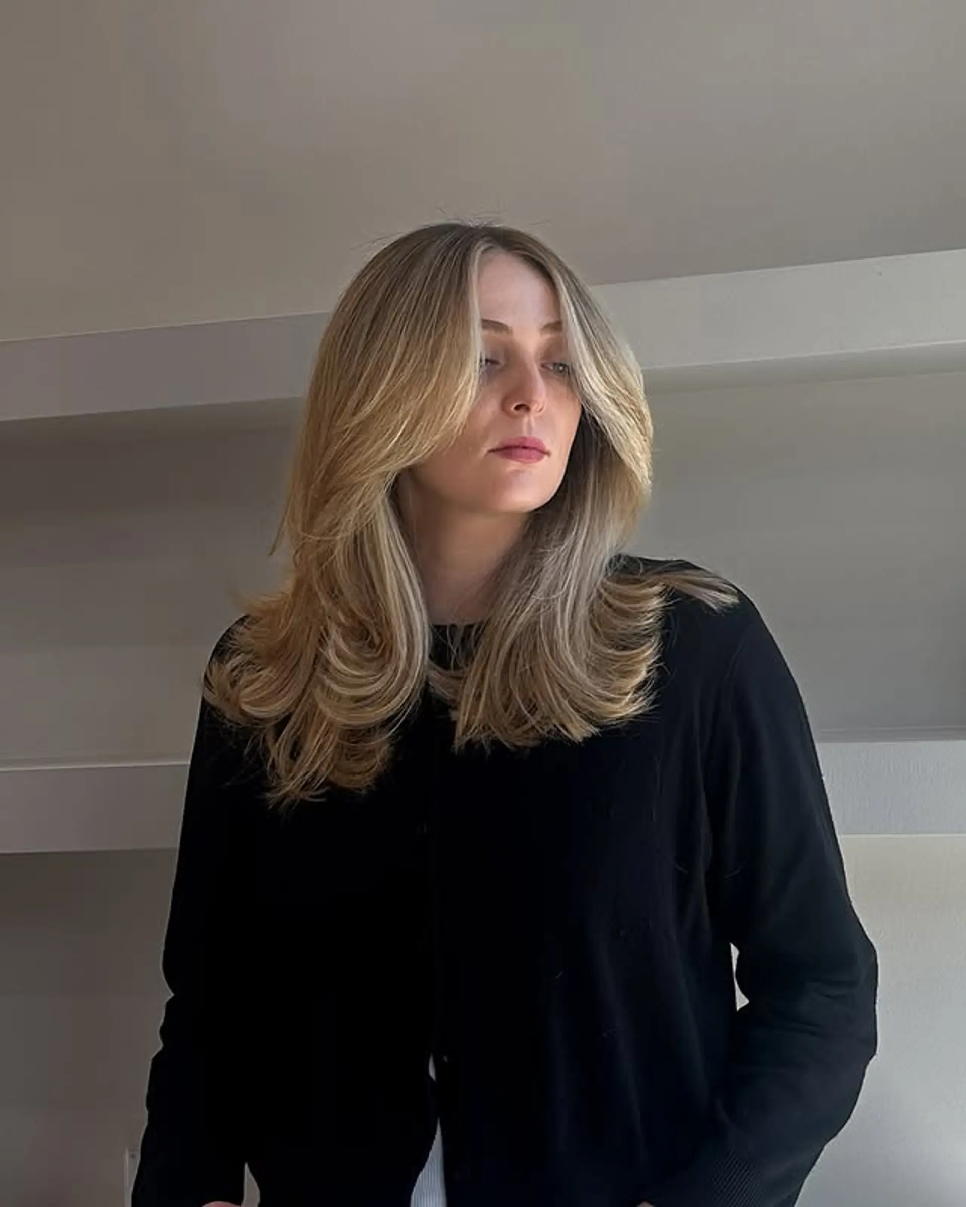A modern shag haircut featuring face-framing layers and soft waves. 1