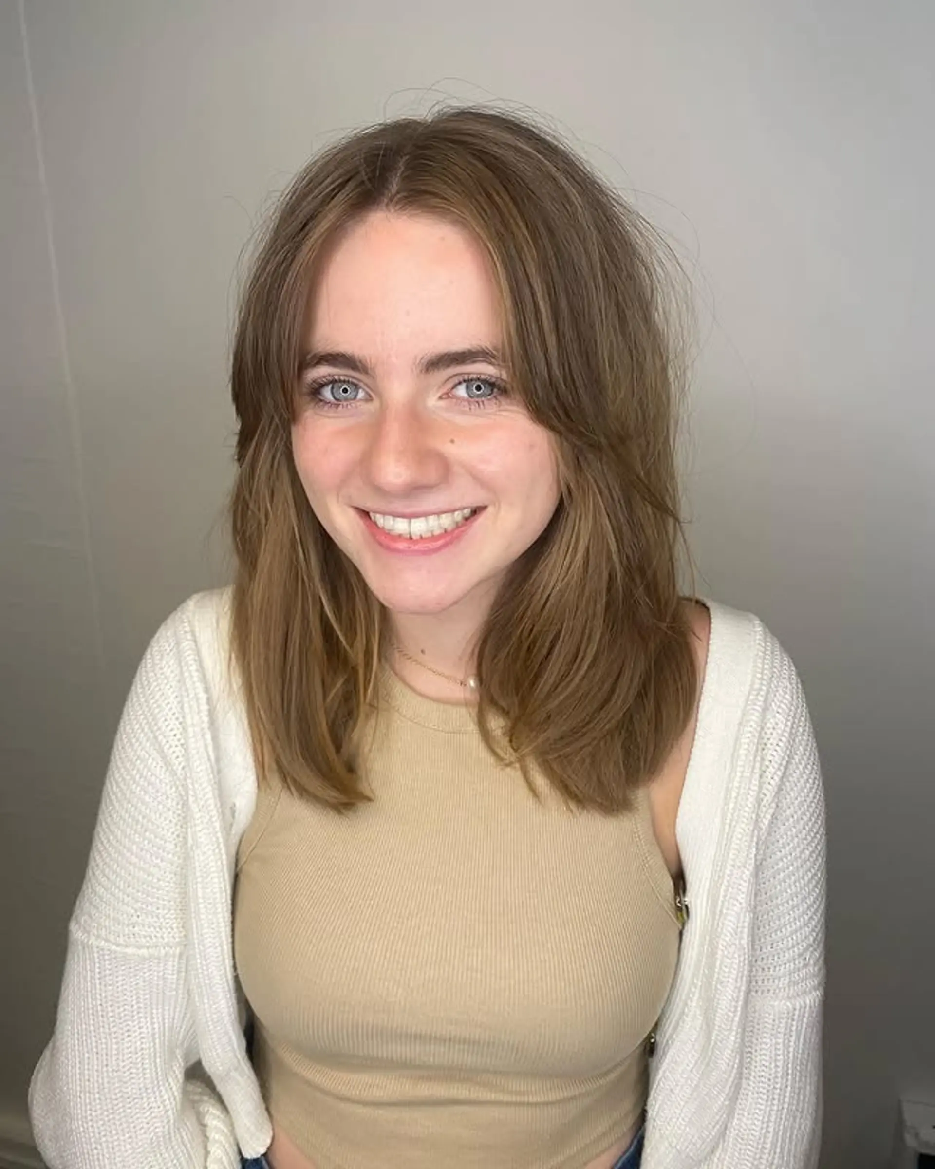 A medium-length cut with curtain bangs and face-framing layers. 1