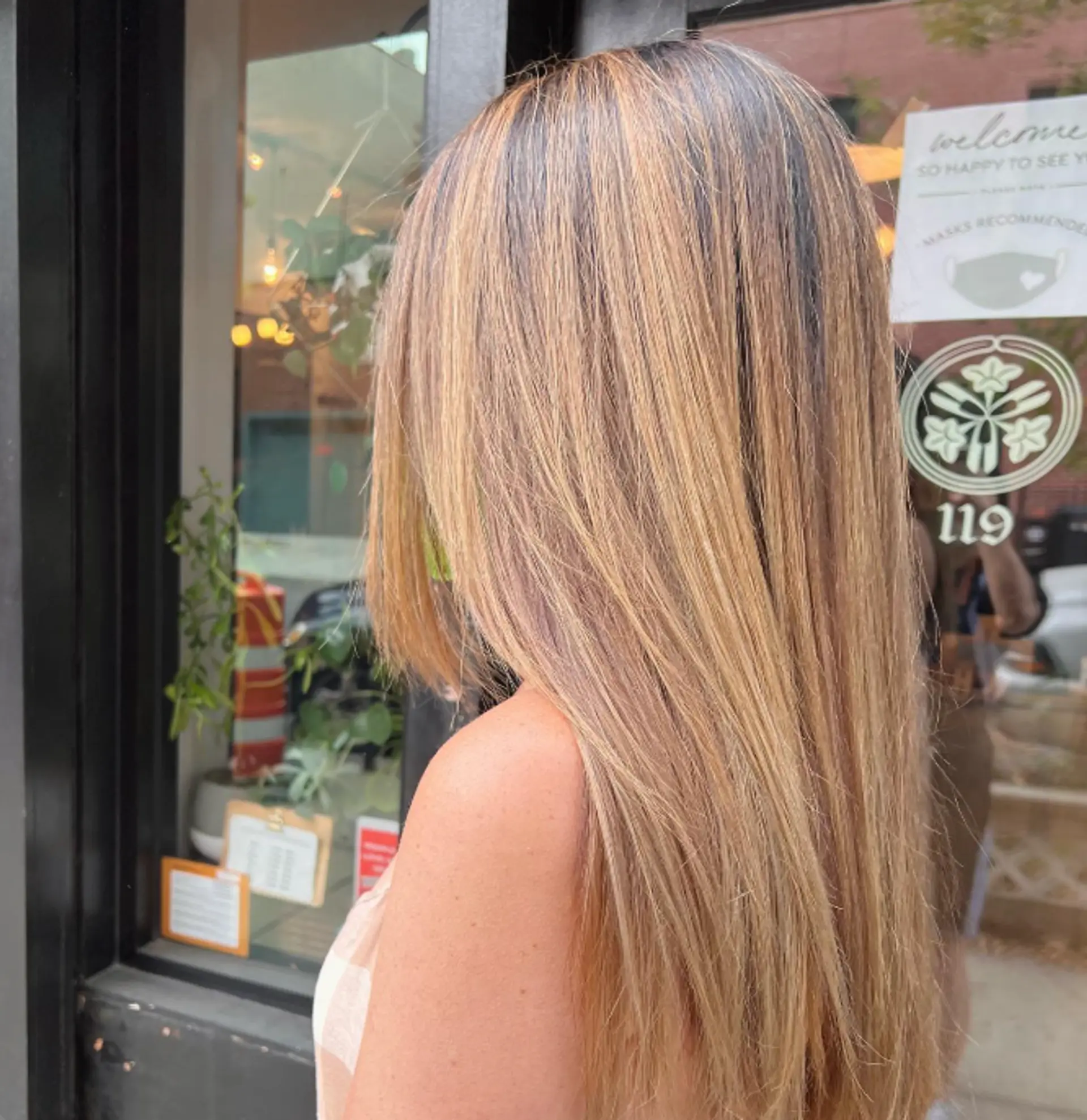 Long, straight layered hair with a golden blonde balayage. 1