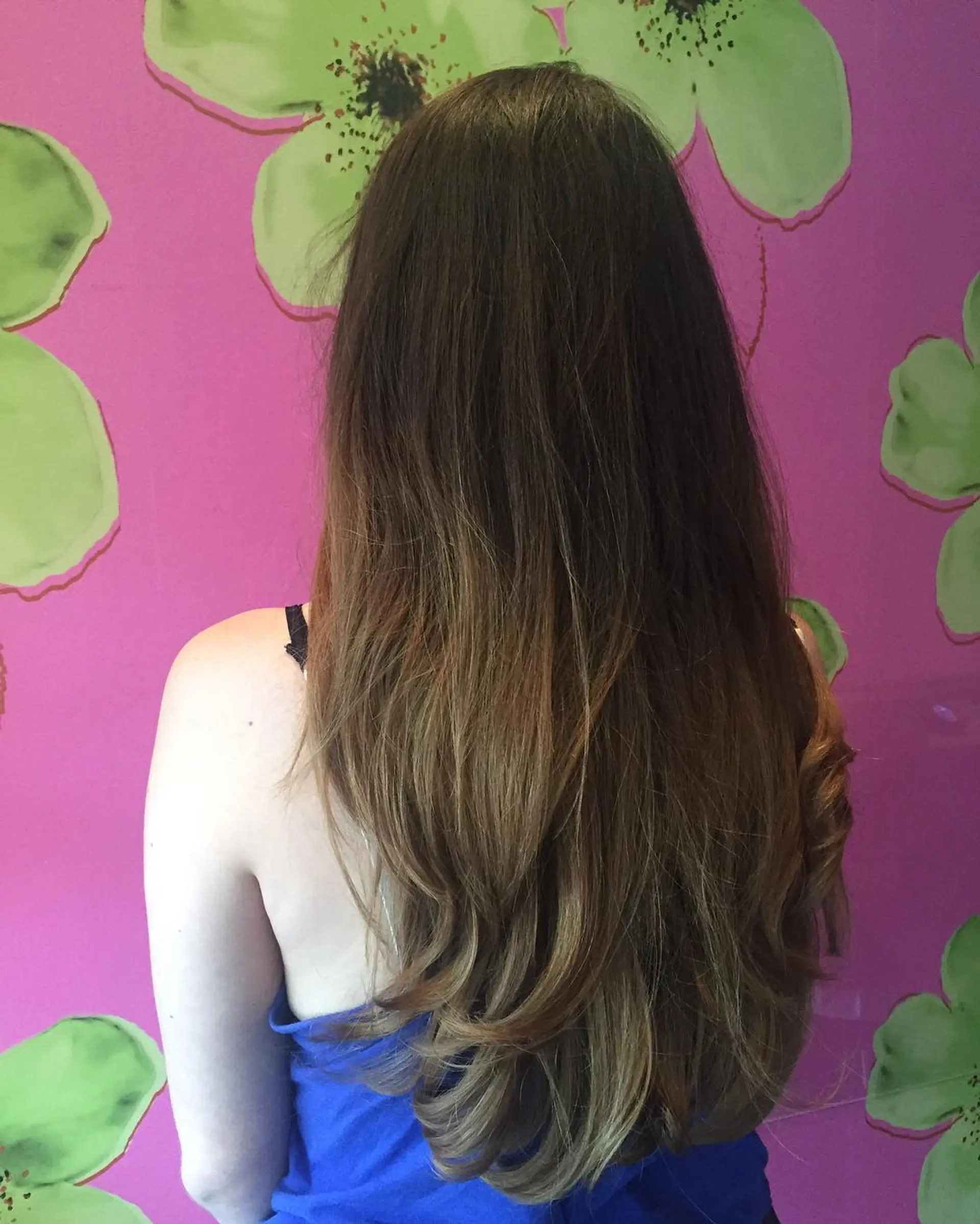 Long, layered hairstyle with a bronde ombre effect and subtle waves. 1