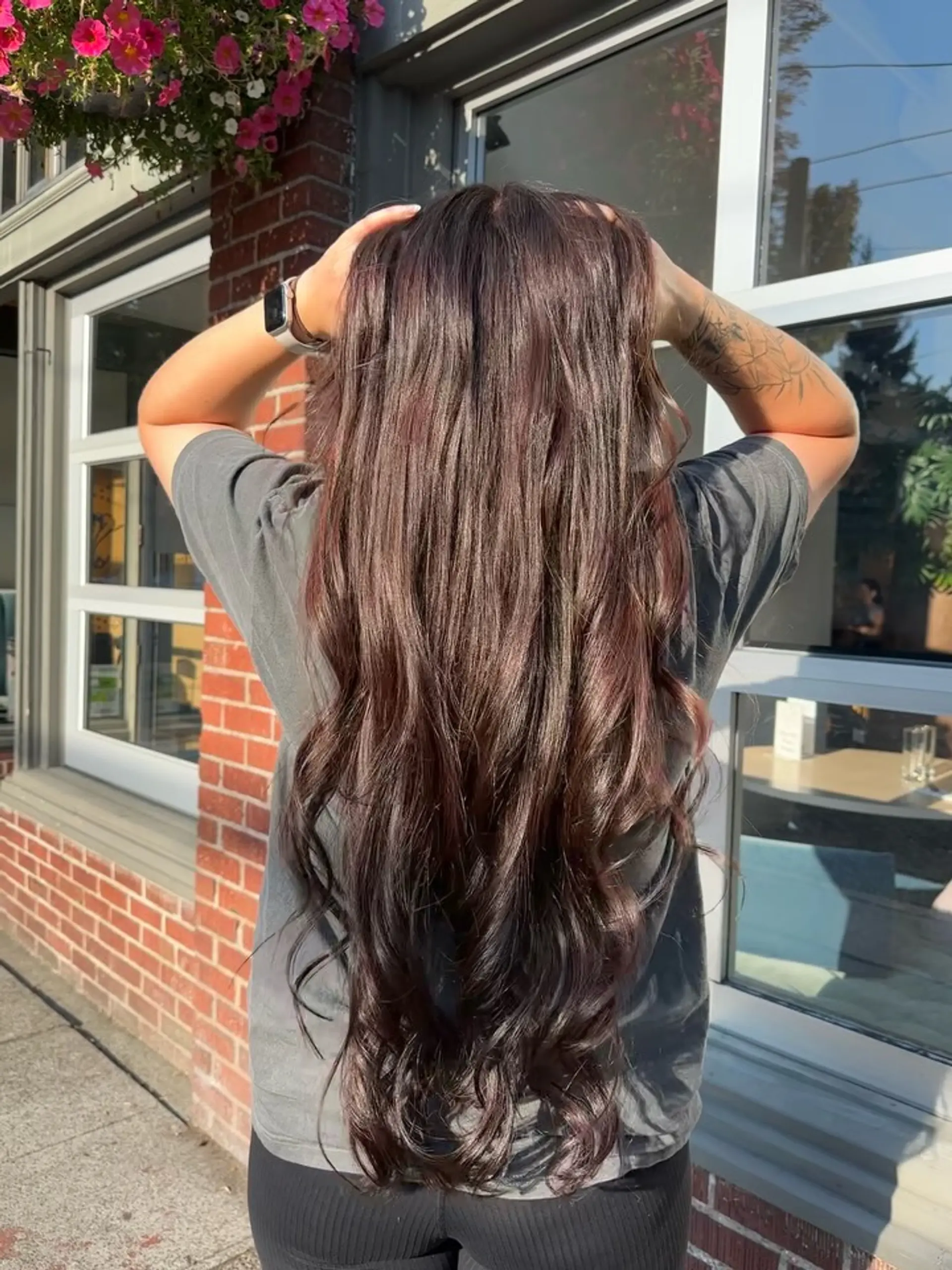 Extra-long rich chocolate brown hair styled smooth with loose, cascading curls at the ends. 1