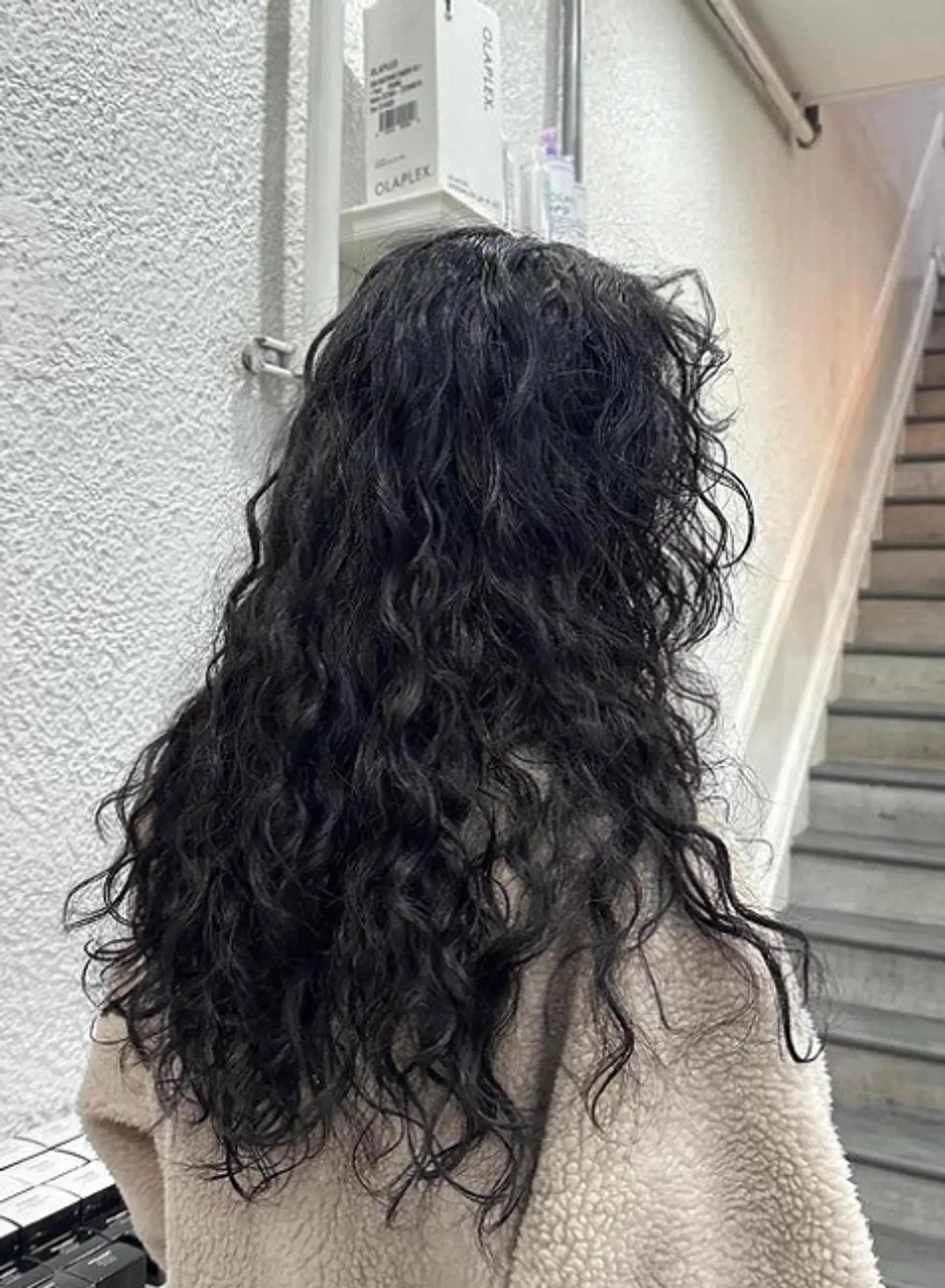 Long, black hair with natural waves cascading down in a loose, windswept style, offering a casual yet elegant look. 2