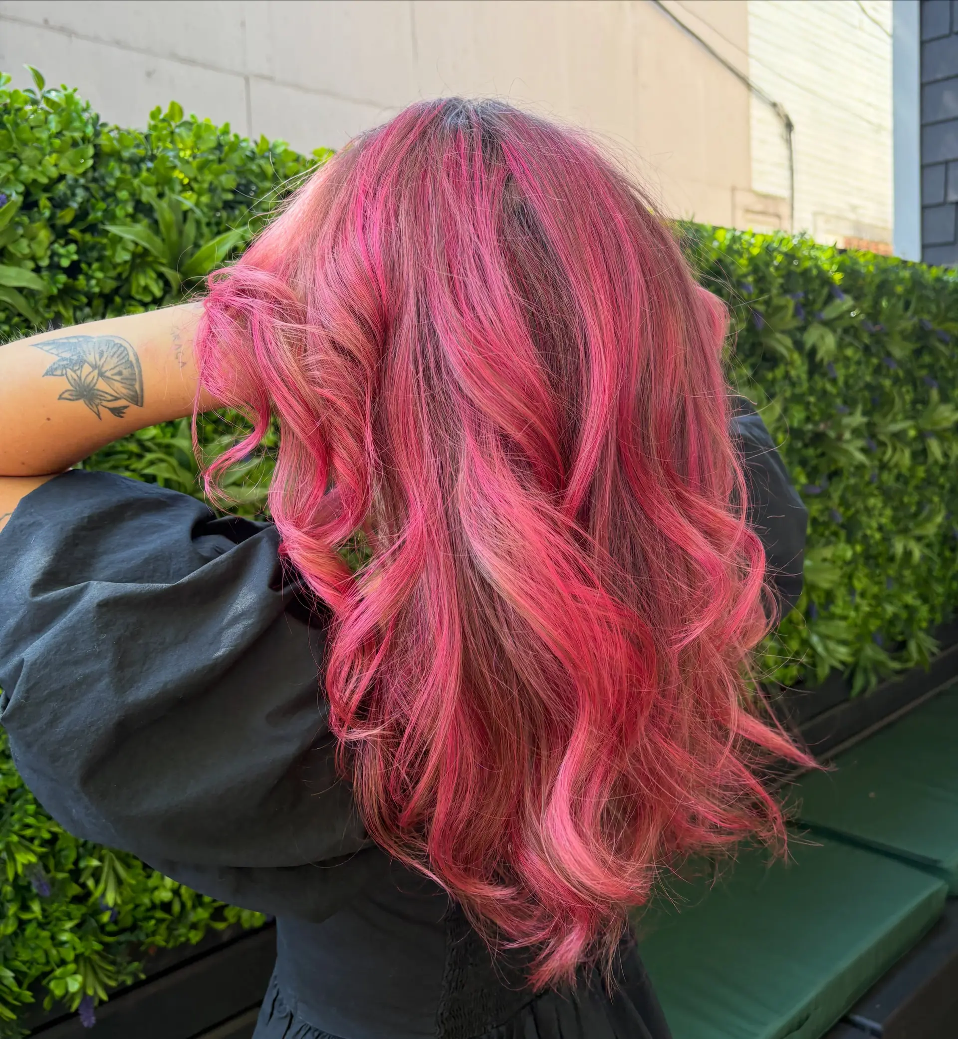A head of long hair dyed in a vivid magenta and hot pink fashion shade, styled into loose, dimensional waves. 1
