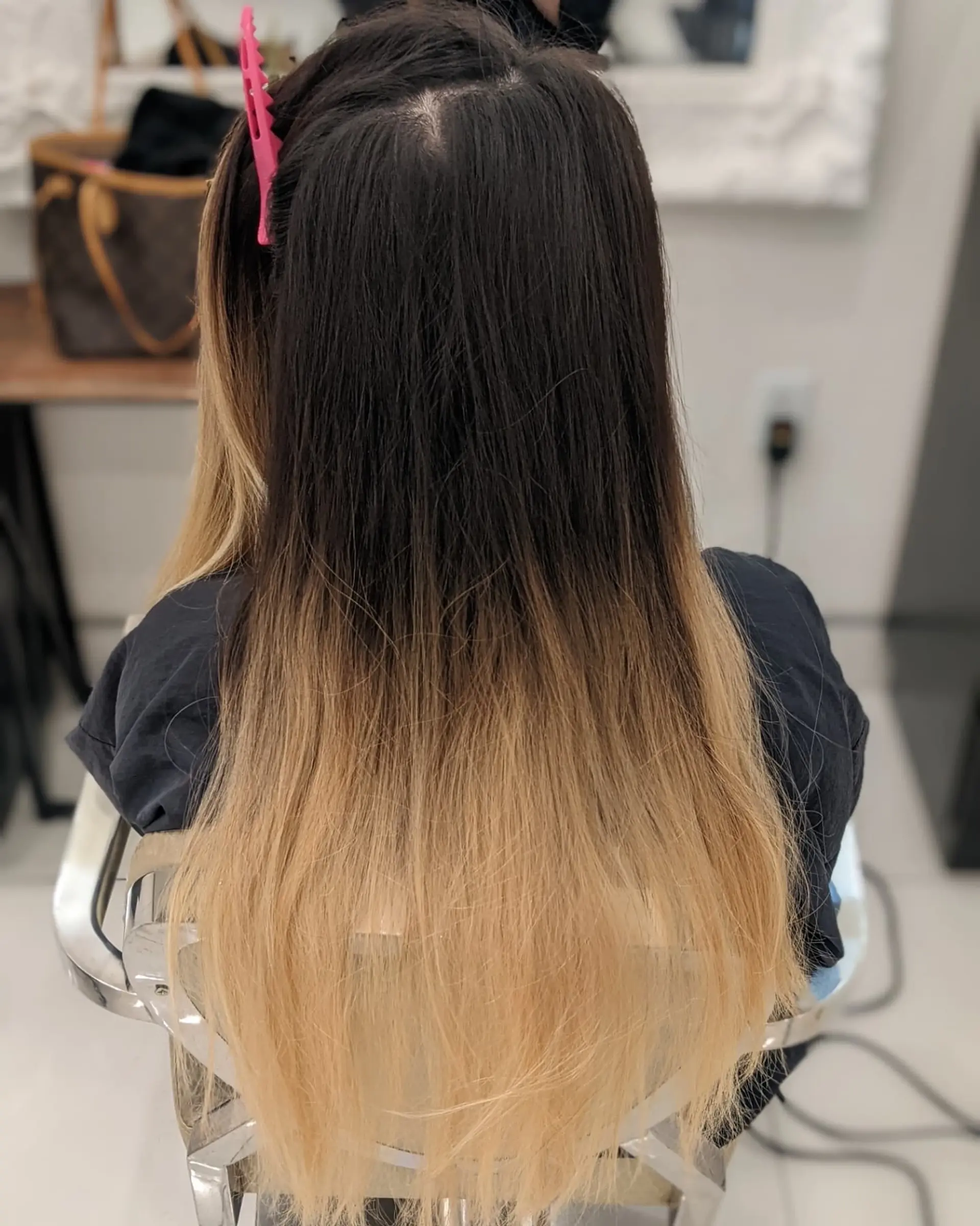 Long, layered hairstyle with a dark to blonde ombre effect. 1