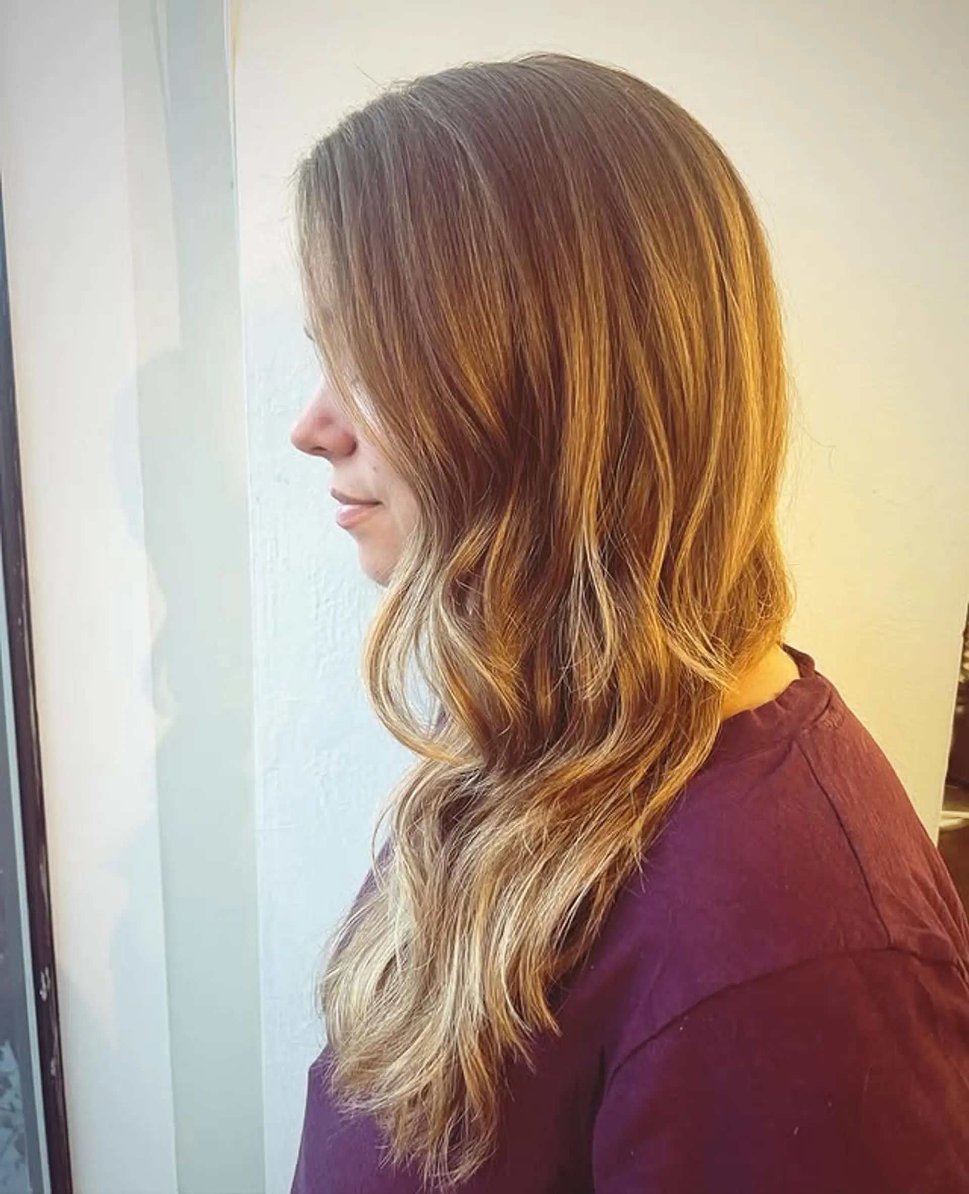 Long layered hair with soft waves and a bronde color. 1