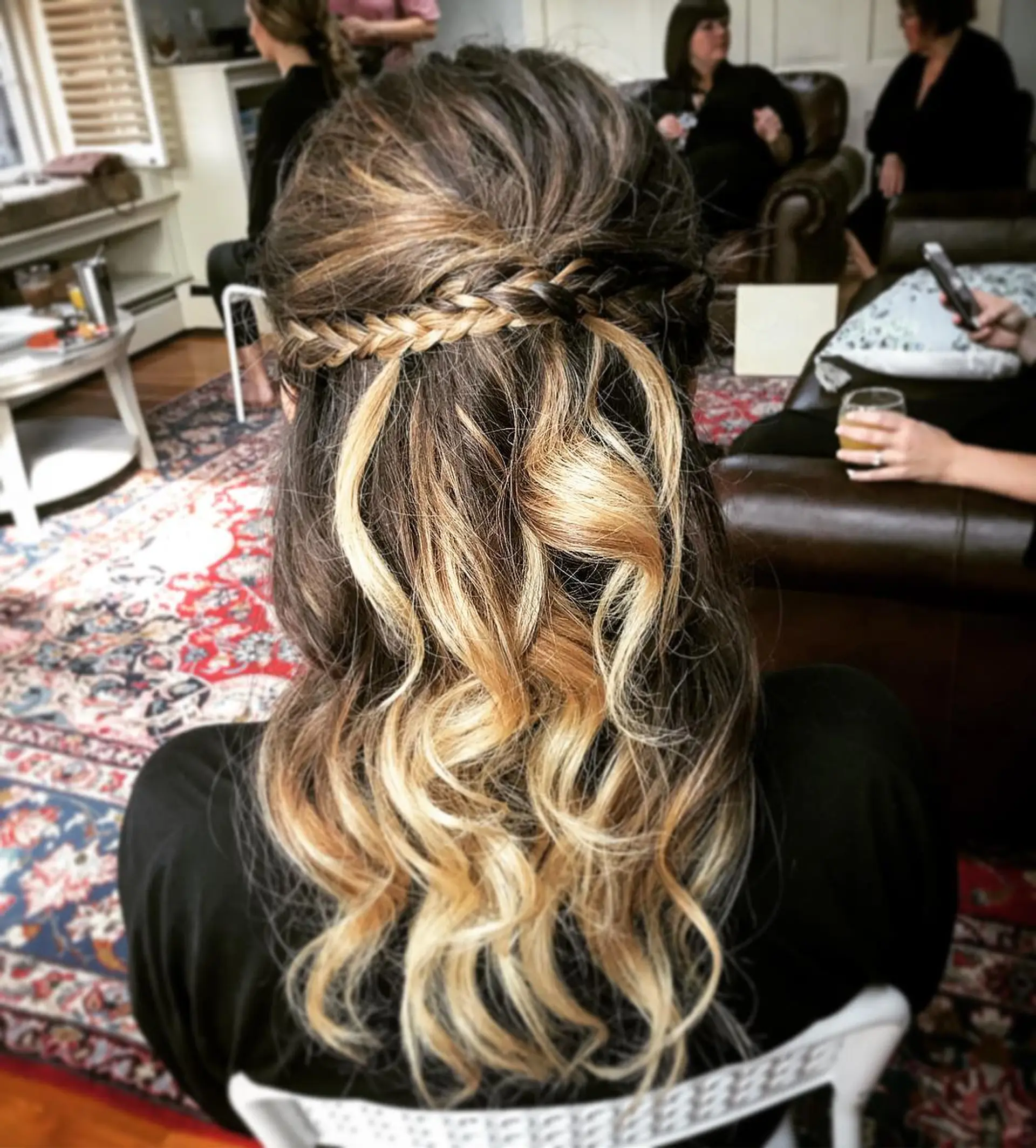 A romantic half-up, half-down hairstyle featuring a delicate horizontal braid across the crown paired with loose, flowing curls. 1
