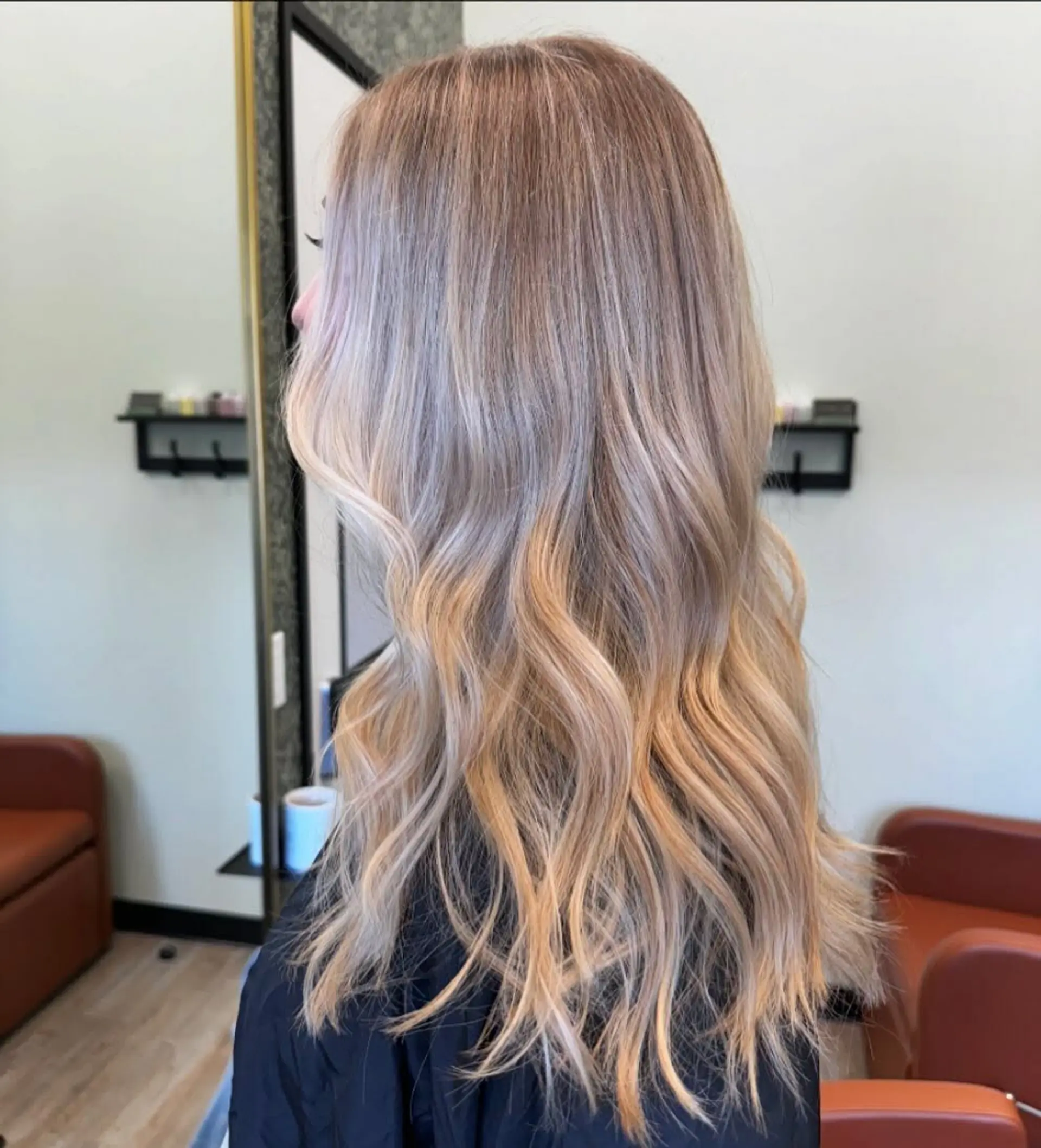 Long dimensional blonde hair styled in soft, loose waves cascading down the back. 1