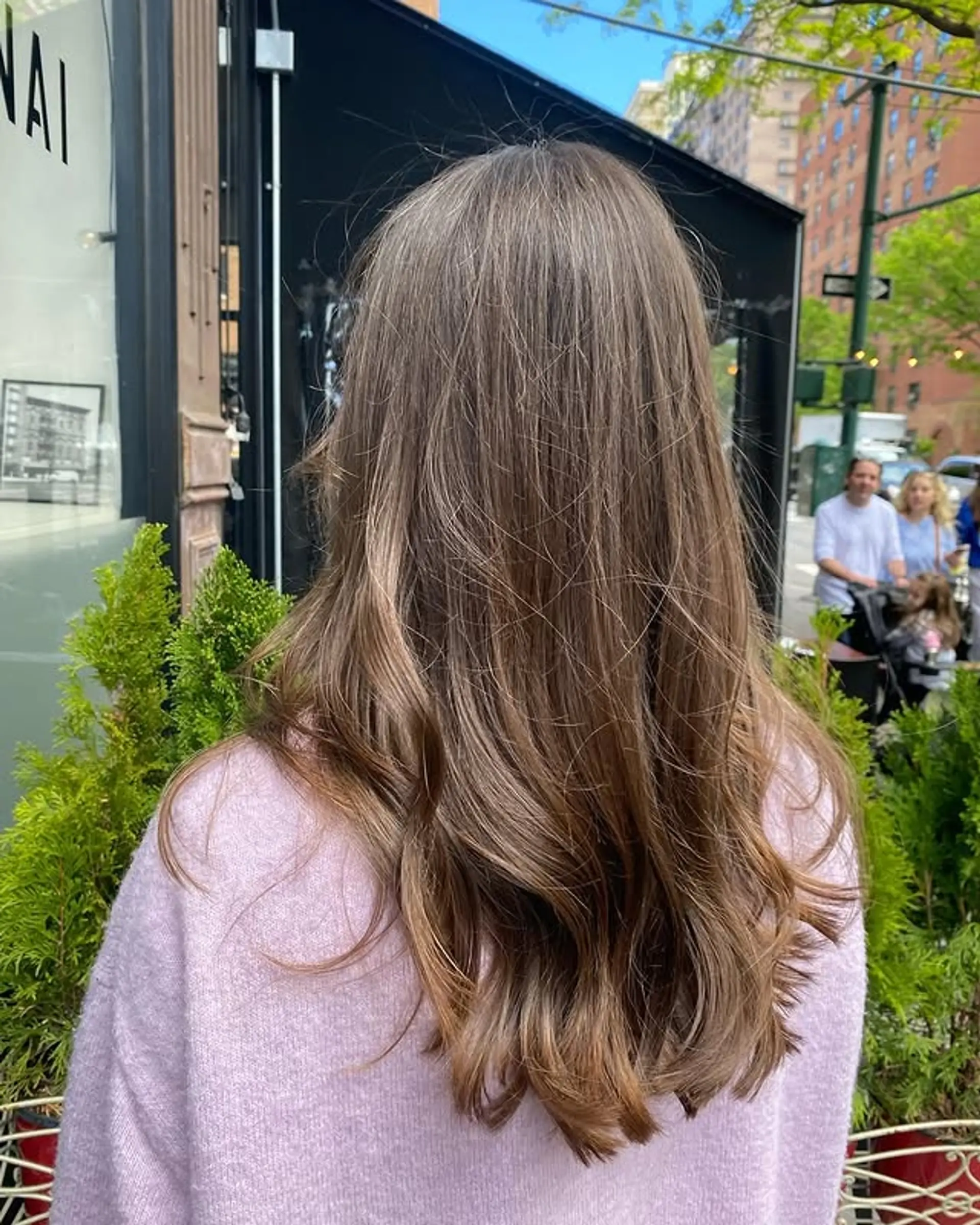 Long, layered brunette hair styled with soft, natural waves. 1