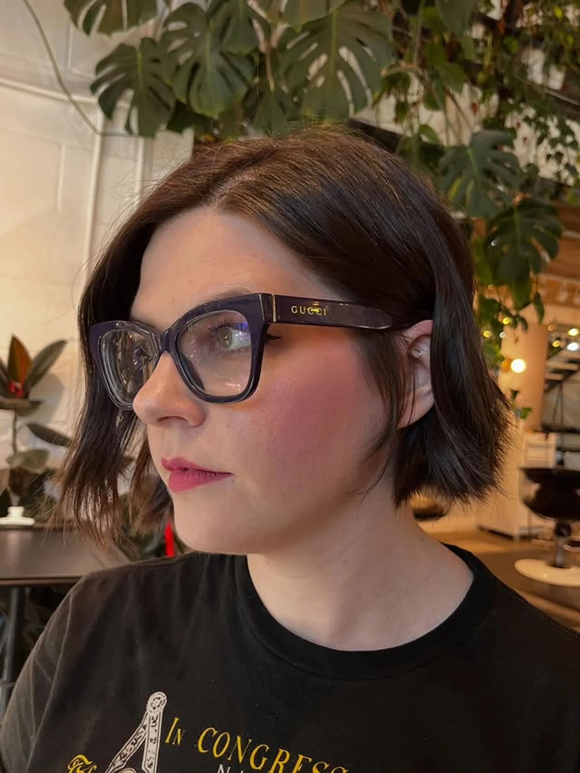 A short, voluminous bob haircut with a side part and soft, bouncy waves on dark hair. - Preview 1