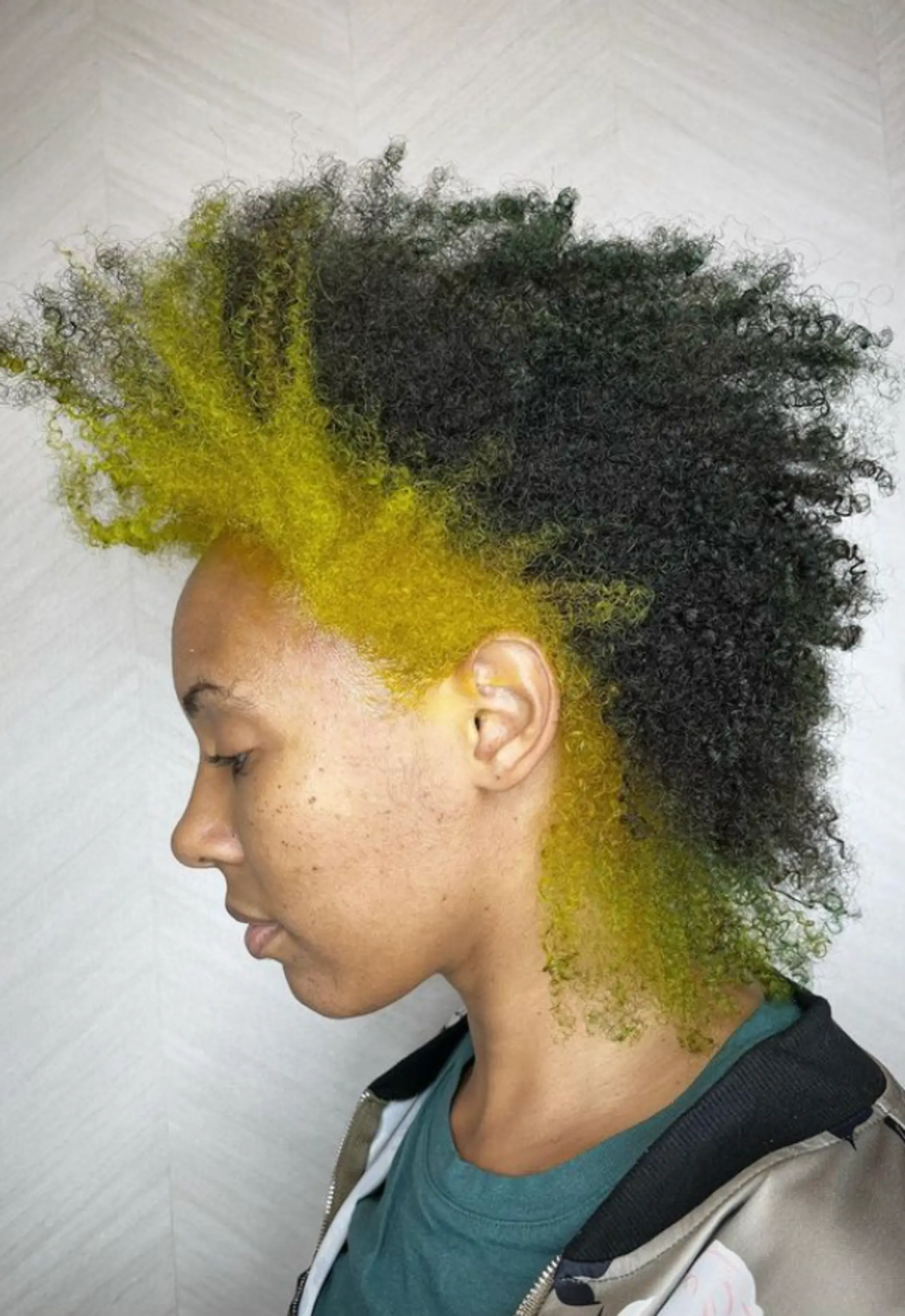 A striking Mohawk with vibrant yellow and black colors, featuring high-volume, coiled texture, short length, and closely shaved sides, creating a bold and playful look.

Color by @simabeautynyc
Cut and style by @juliamannino_hair
 1