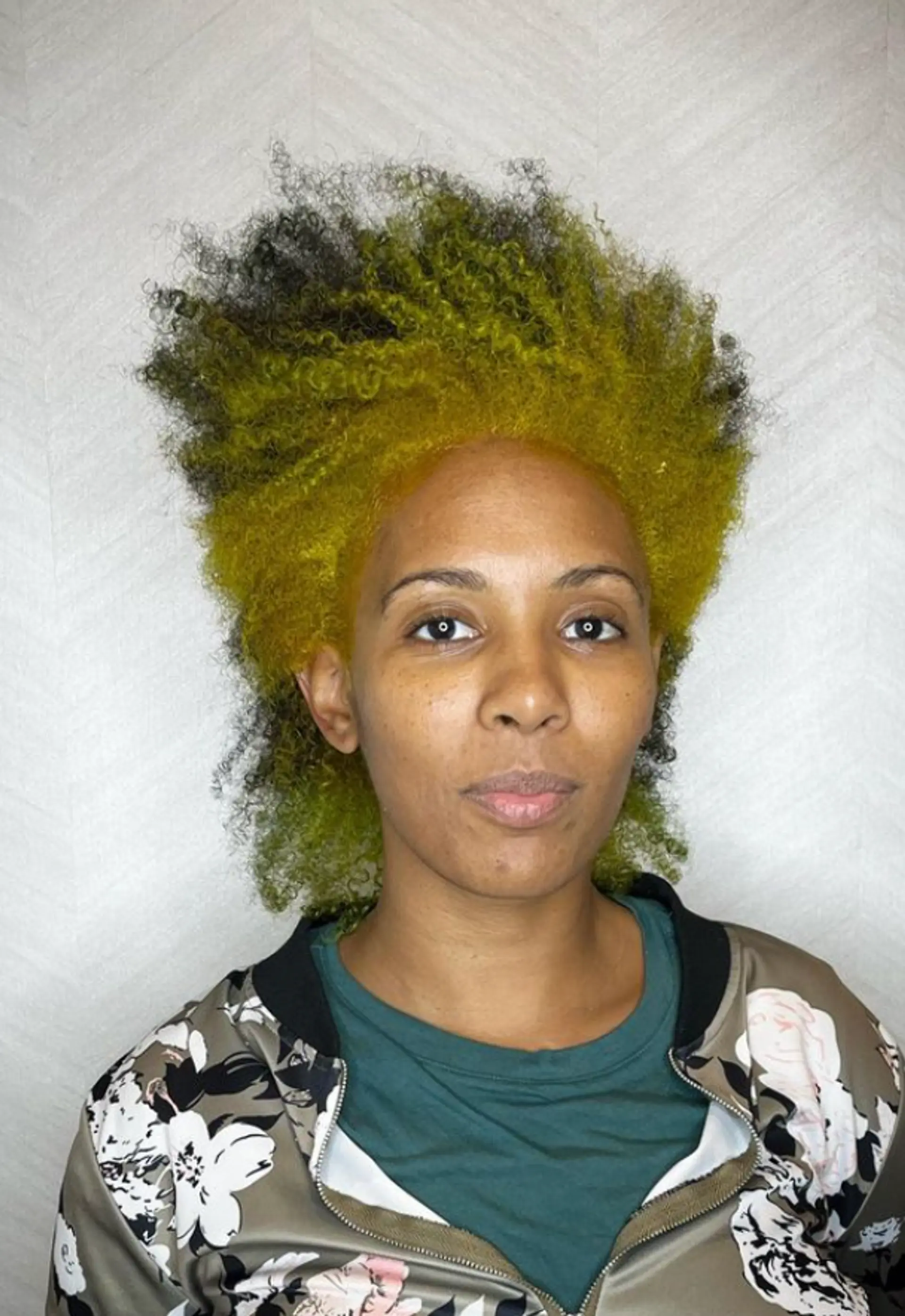 A striking Mohawk with vibrant yellow and black colors, featuring high-volume, coiled texture, short length, and closely shaved sides, creating a bold and playful look.

Color by @simabeautynyc
Cut and style by @juliamannino_hair
 2