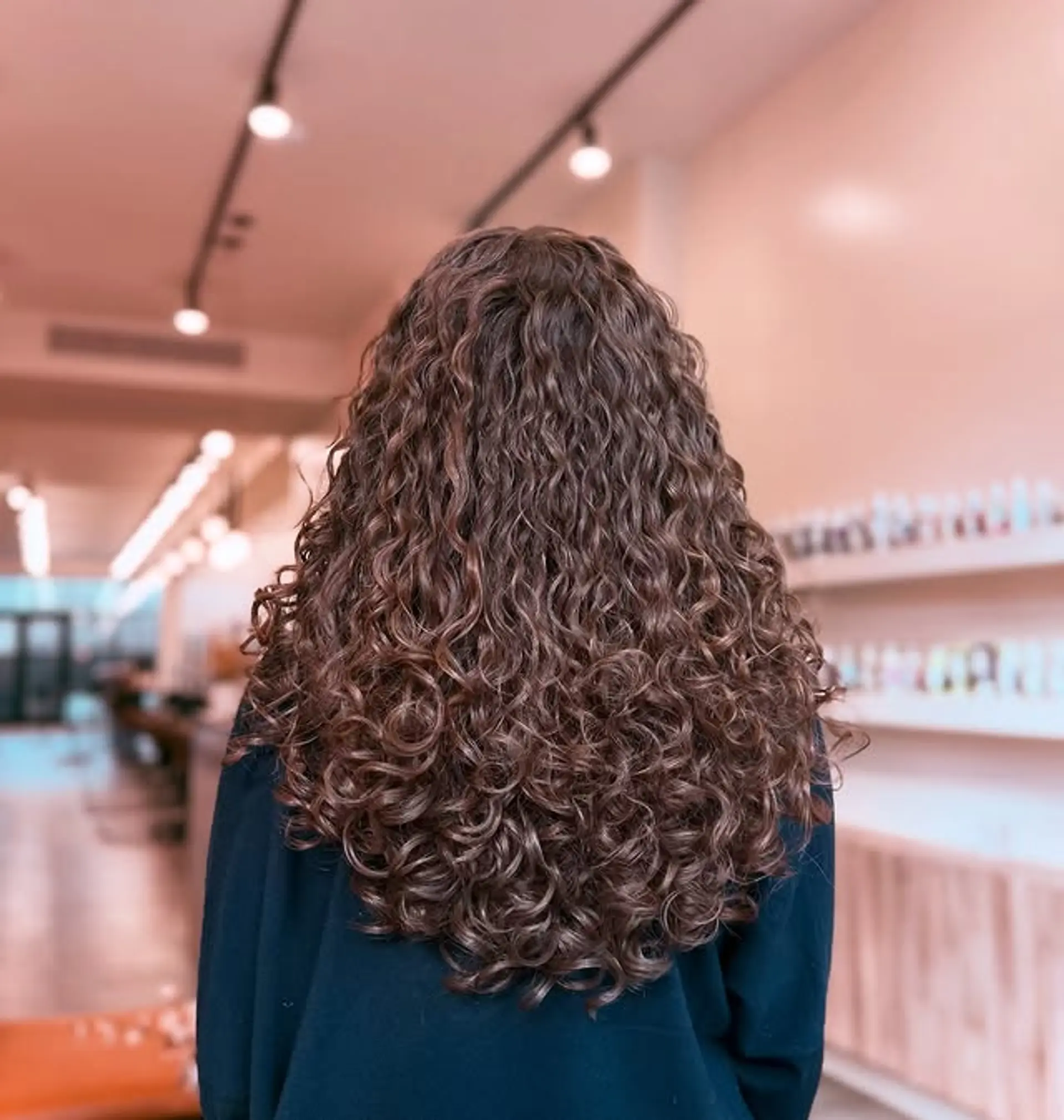 Long, voluminous curly hairstyle with defined curls. 1