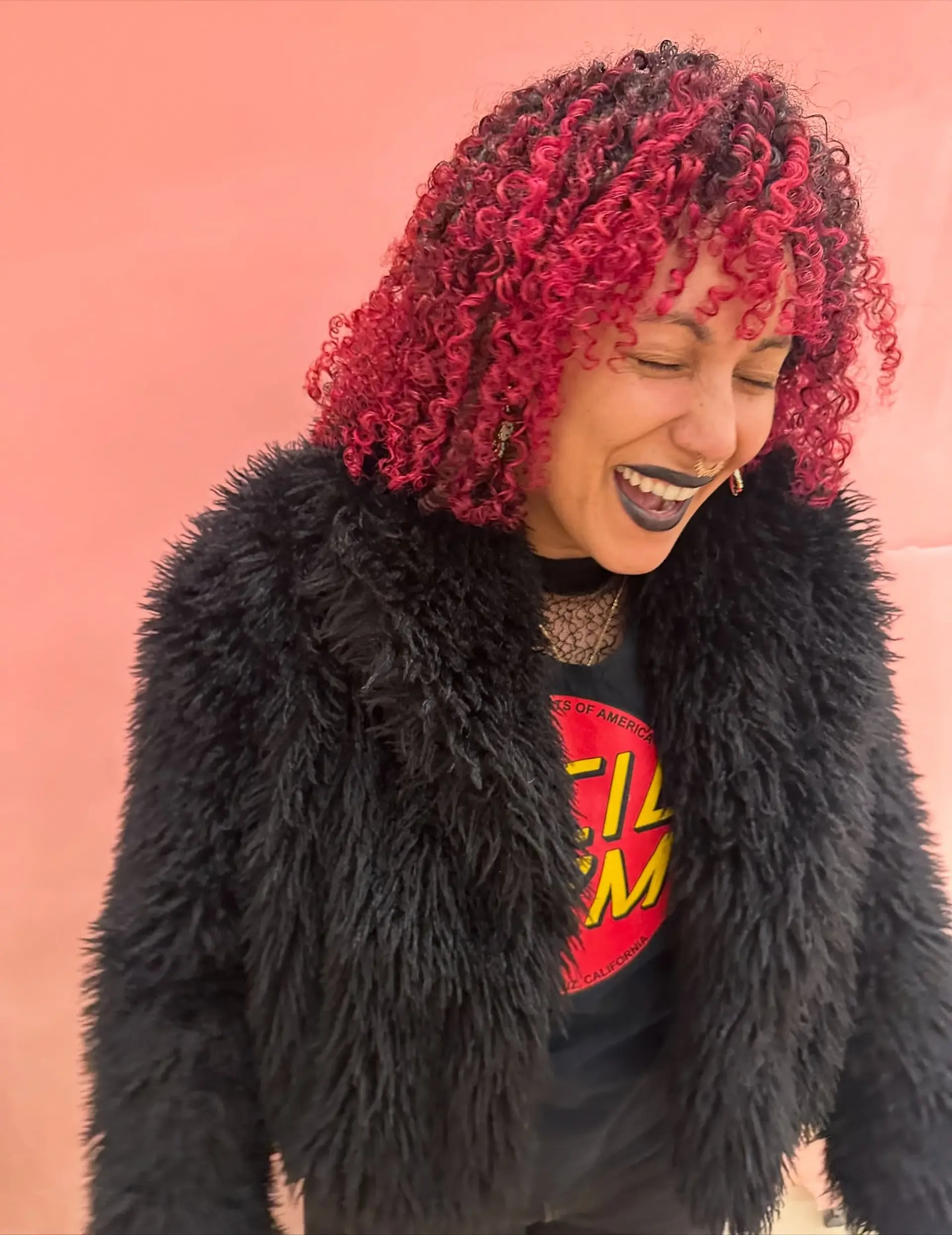 Shoulder-length defined curls featuring vivid magenta and pink balayage highlights paired with a curly fringe. 1