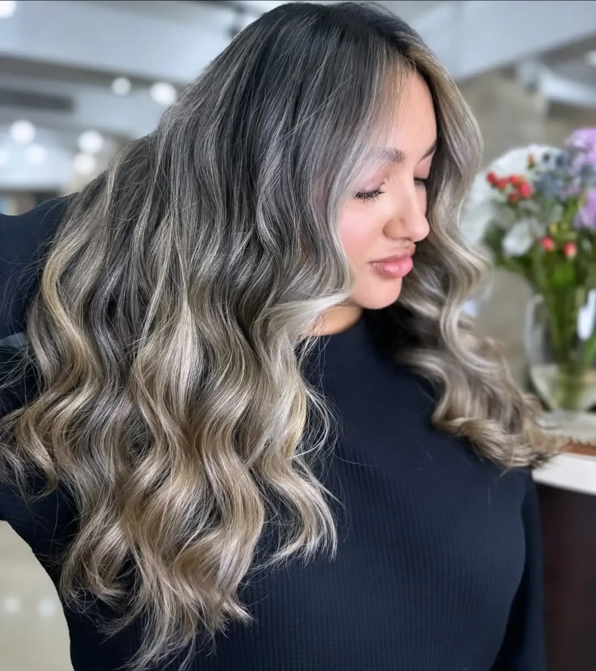 Long, wavy hair featuring a bronde balayage with a dimensional color effect. 1