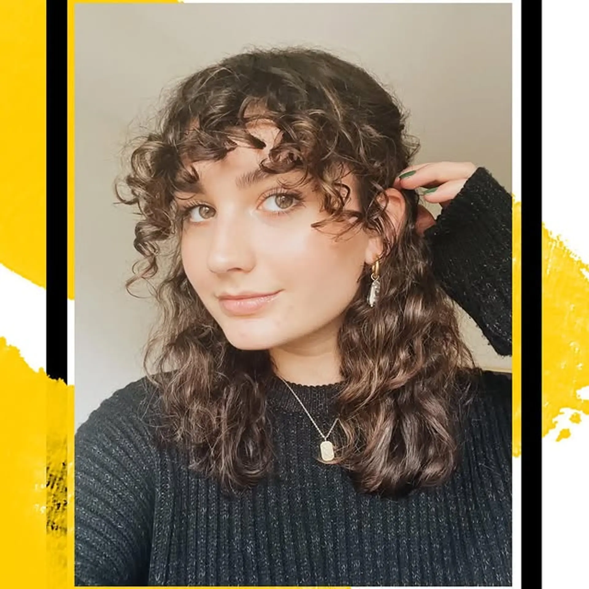 A trendy medium-length shag haircut with curly texture and bangs. 1