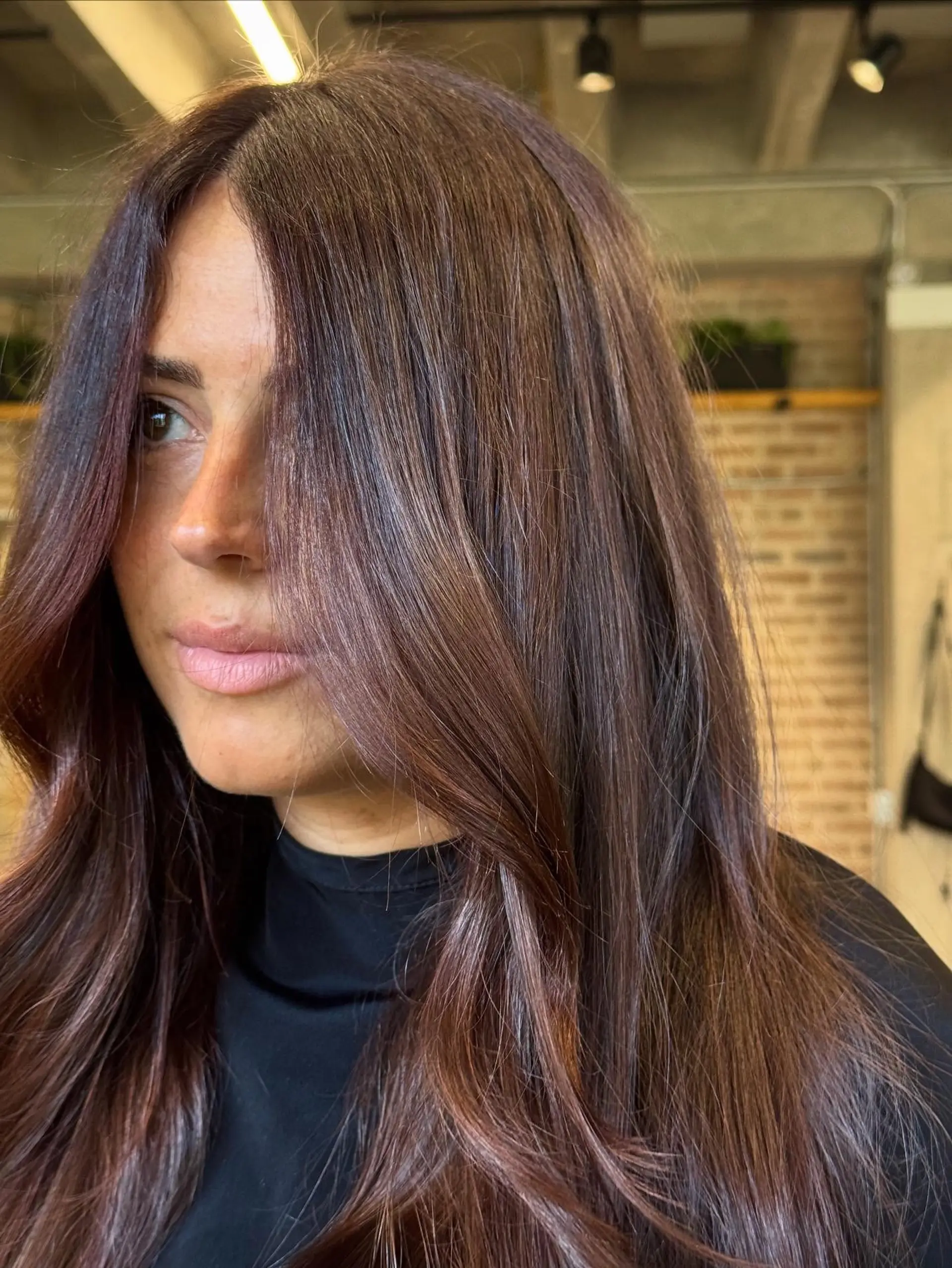 A long, flowing hairstyle with a center part and soft, face-framing layers that gently cascade into natural-looking waves. The ends are styled with a soft bend, creating volume and movement. 3
