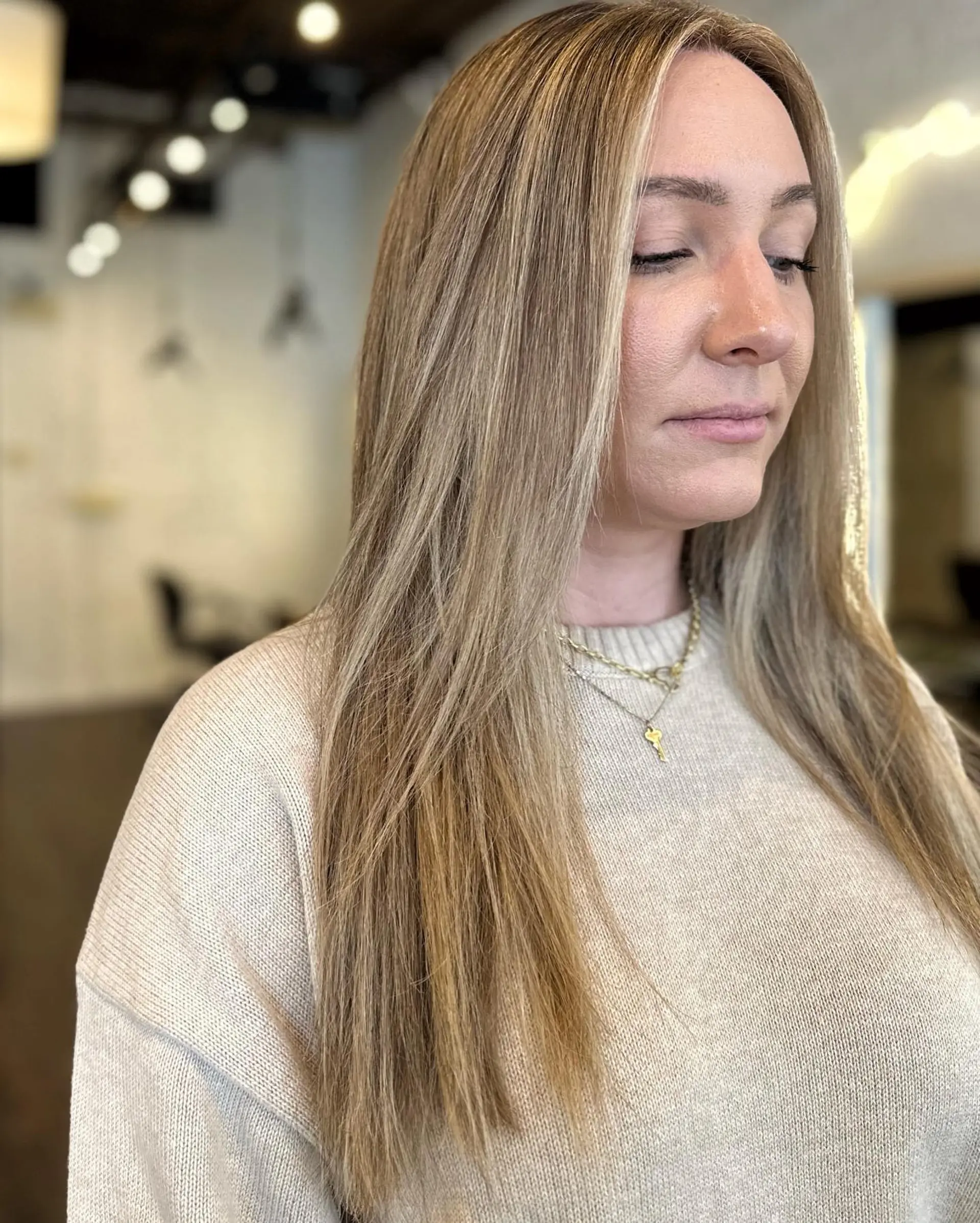 Long, straight layered hair with a bronde balayage. 1