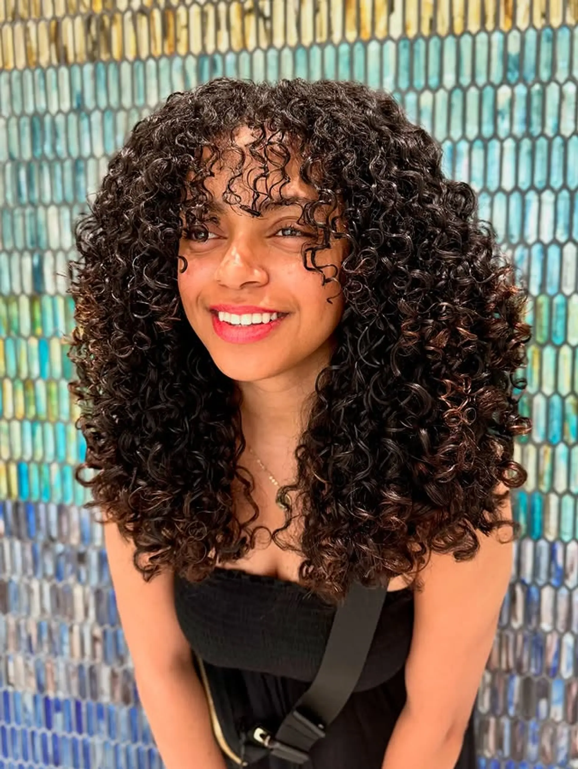 A medium-length curly shag with face-framing bangs. 1